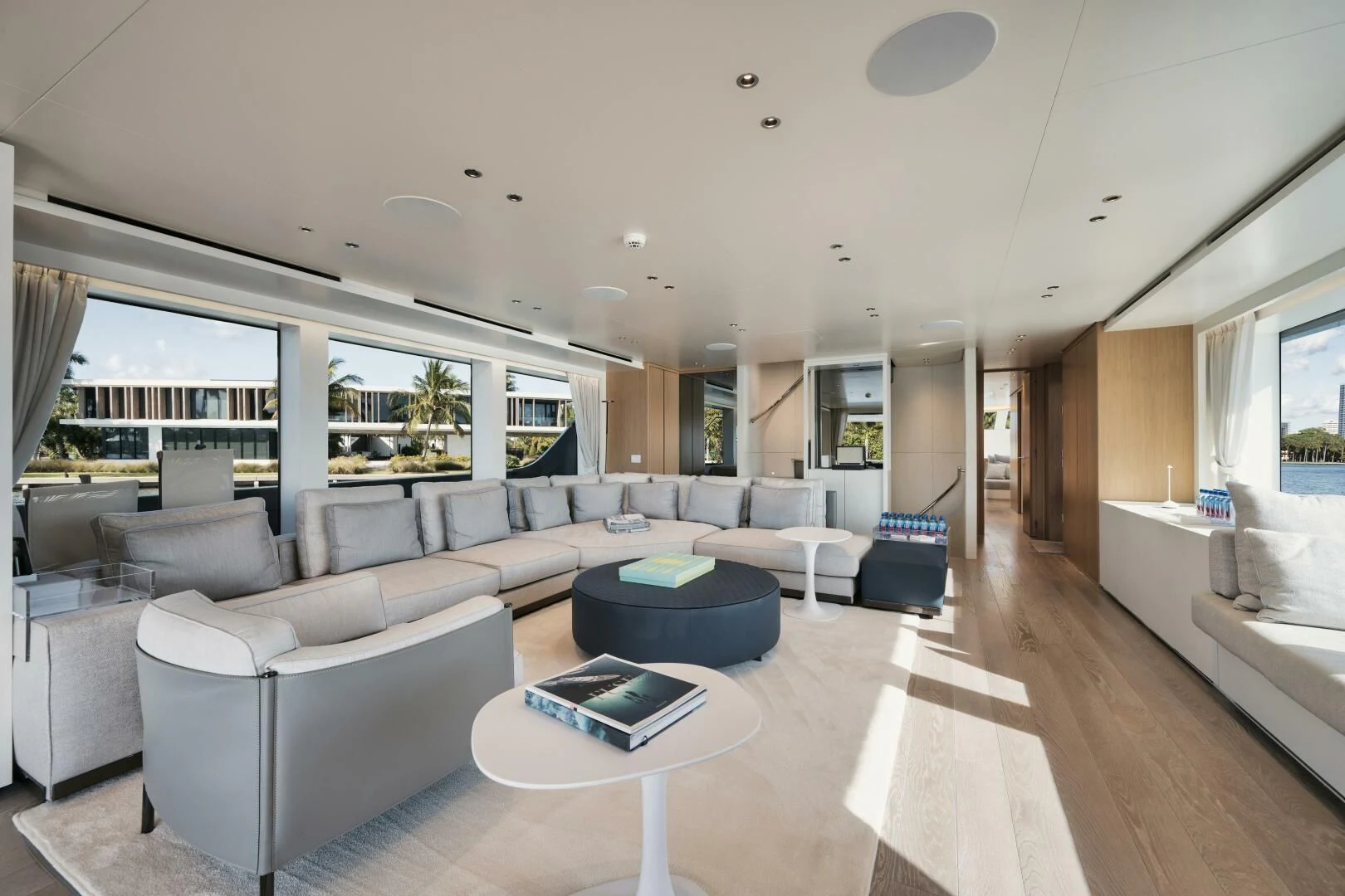 a living room with a large white sofa and a large window aboard DON'T TELL MOM Yacht for Sale