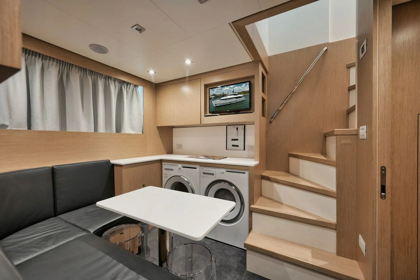 a room with a couch and a television aboard DON'T TELL MOM Yacht for Sale