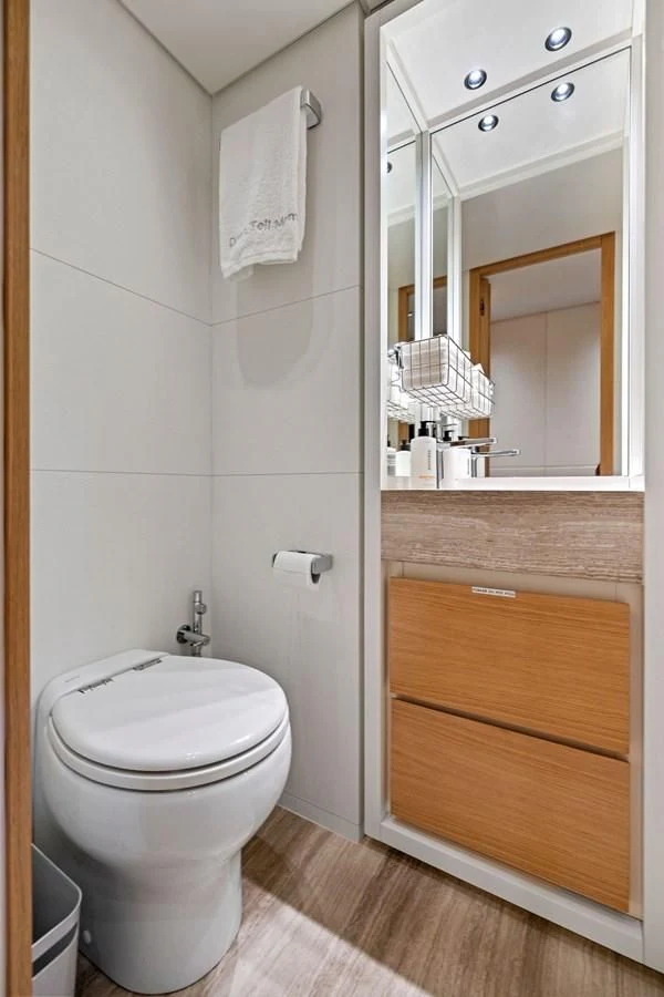 a bathroom with a toilet and a mirror aboard DON'T TELL MOM Yacht for Sale