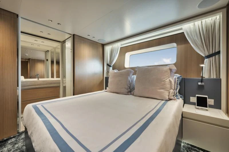 a bed with a blue and white bed spread aboard DON'T TELL MOM Yacht for Sale