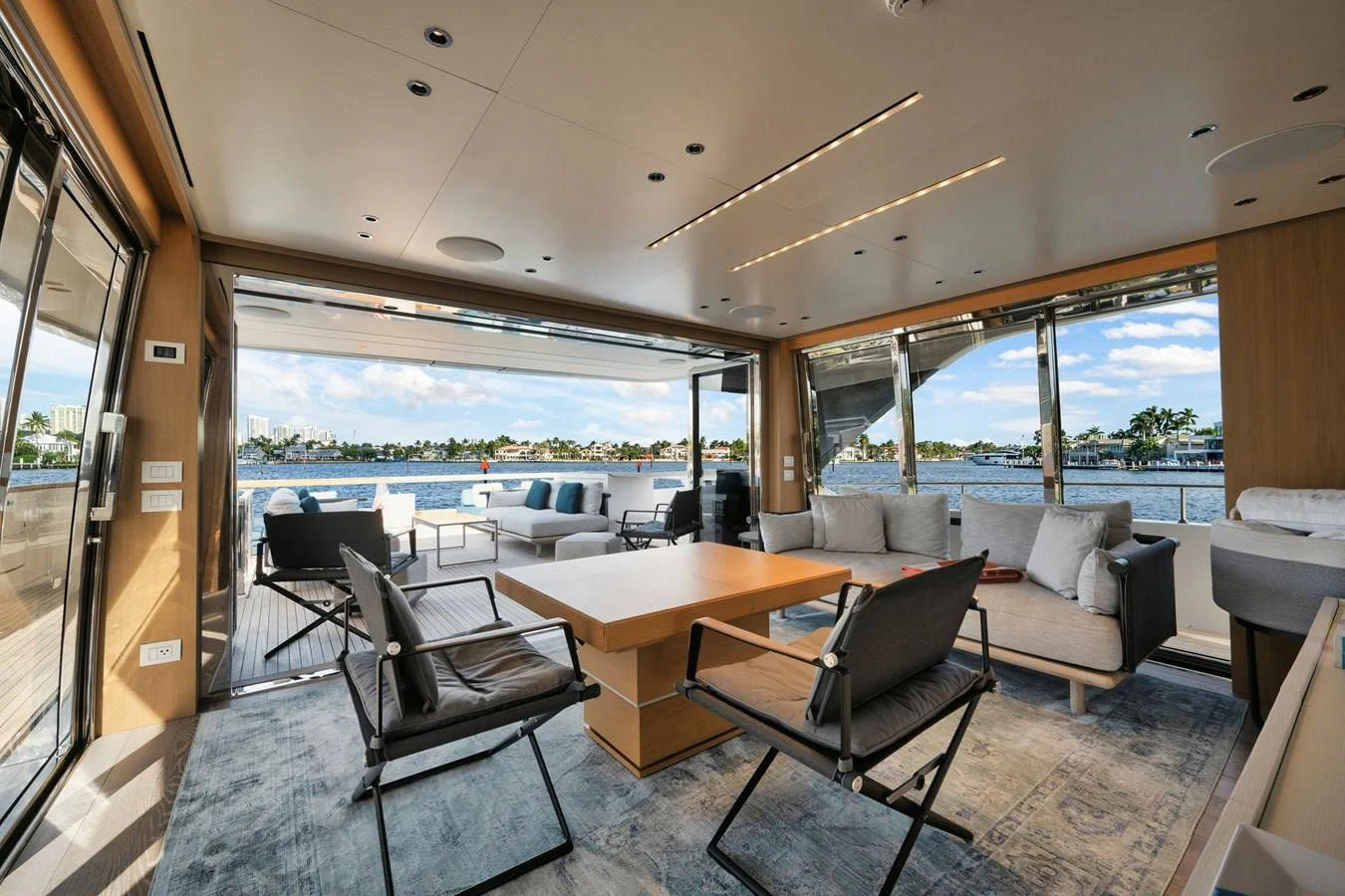 a room with a table chairs and a view of the water aboard DON'T TELL MOM Yacht for Sale