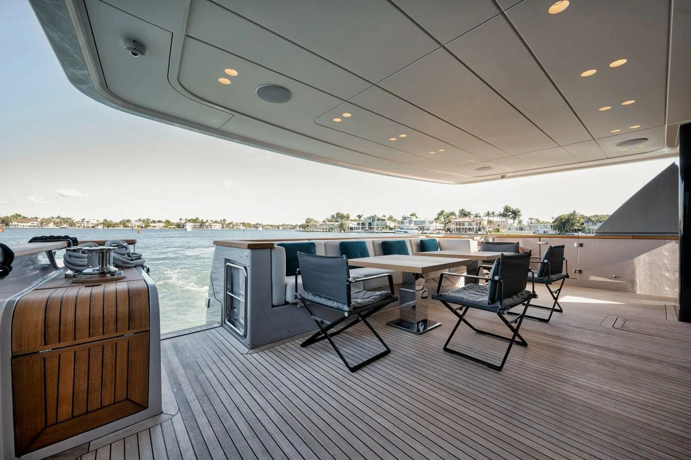 a room with a table chairs and a large pool aboard DON'T TELL MOM Yacht for Sale