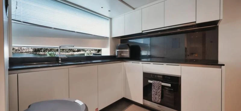 a kitchen with white cabinets aboard DON'T TELL MOM Yacht for Sale