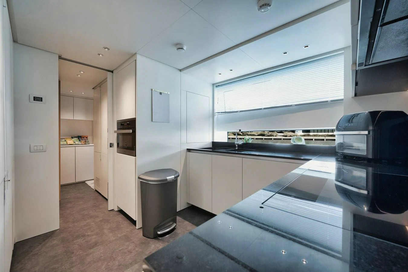a kitchen with a large window aboard DON'T TELL MOM Yacht for Sale