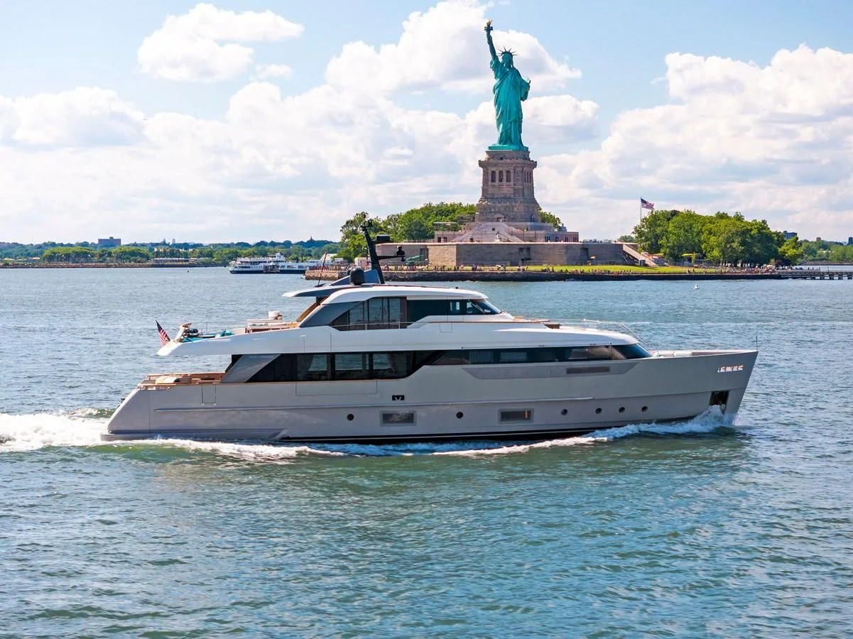 a boat in the water with a statue of liberty in the background aboard DON'T TELL MOM Yacht for Sale