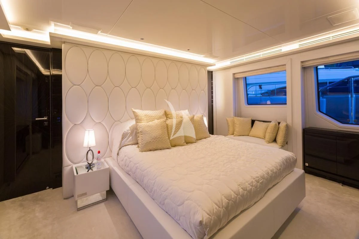 a bedroom with a bed and a window aboard GALA Yacht for Sale