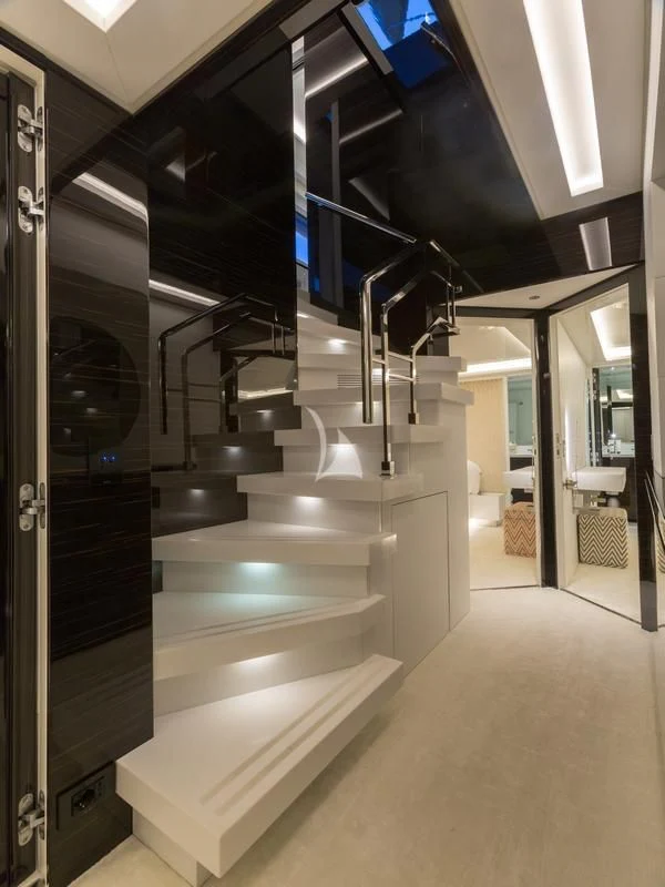 a large room with a staircase and a large glass window aboard GALA Yacht for Sale