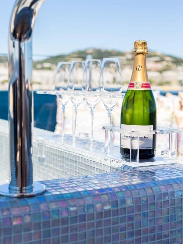 a bottle of wine and several glasses aboard GALA Yacht for Sale