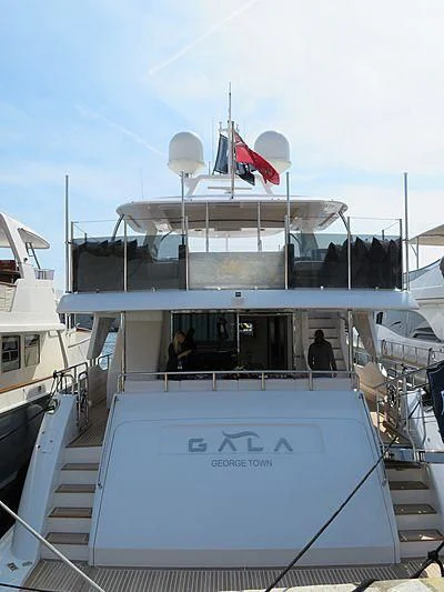 a boat with a flag on the front aboard GALA Yacht for Sale