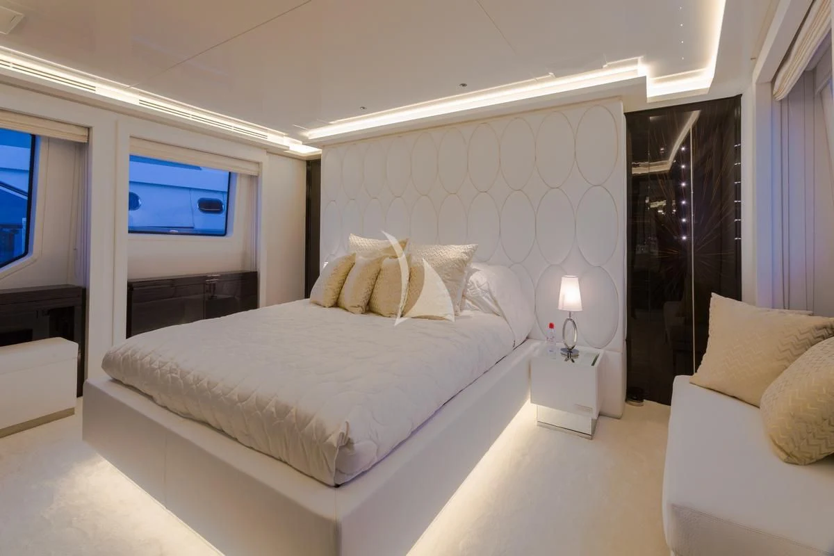 a bed with white sheets aboard GALA Yacht for Sale