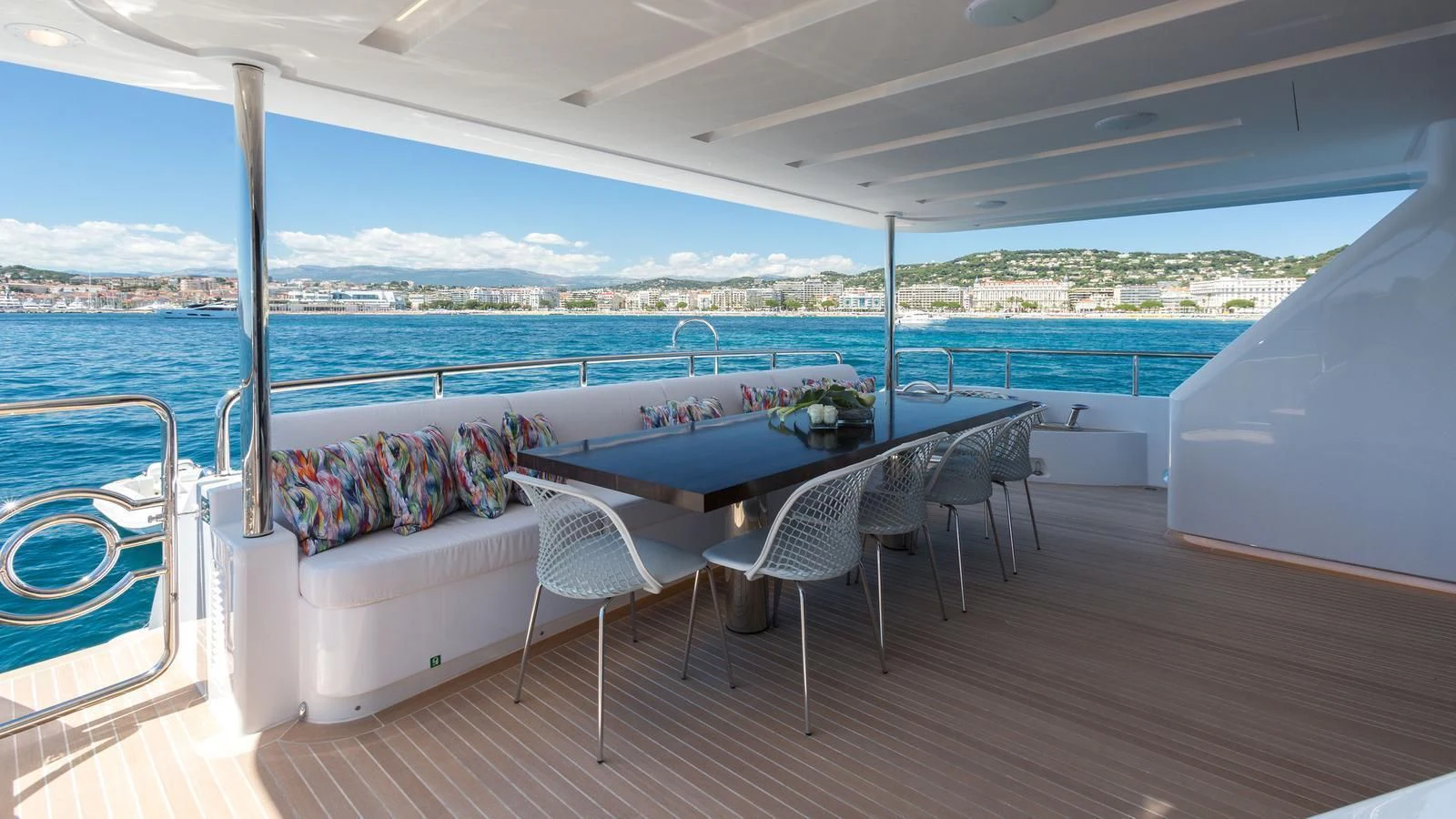 a deck with a table and chairs aboard GALA Yacht for Sale