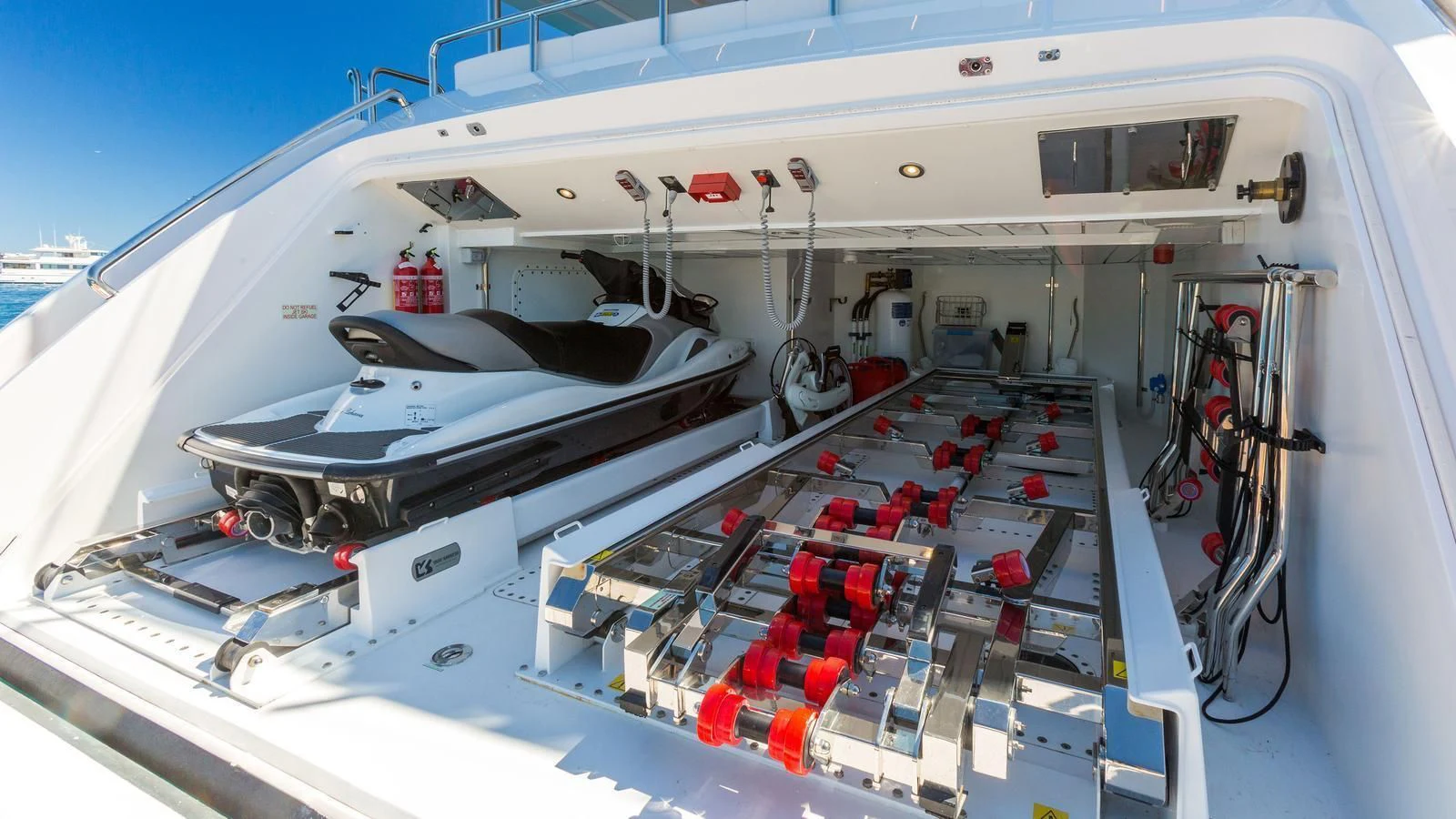 a large white ship with red and black containers aboard GALA Yacht for Sale