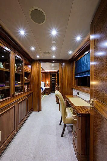 a long hallway with a table and chairs aboard BLUE TIME Yacht for Sale