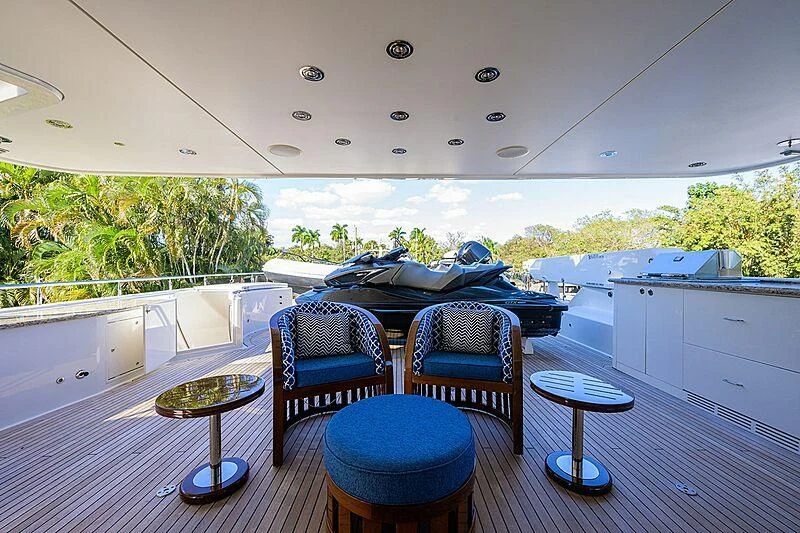 a room with a table chairs and a bed on a balcony aboard BLUE TIME Yacht for Sale