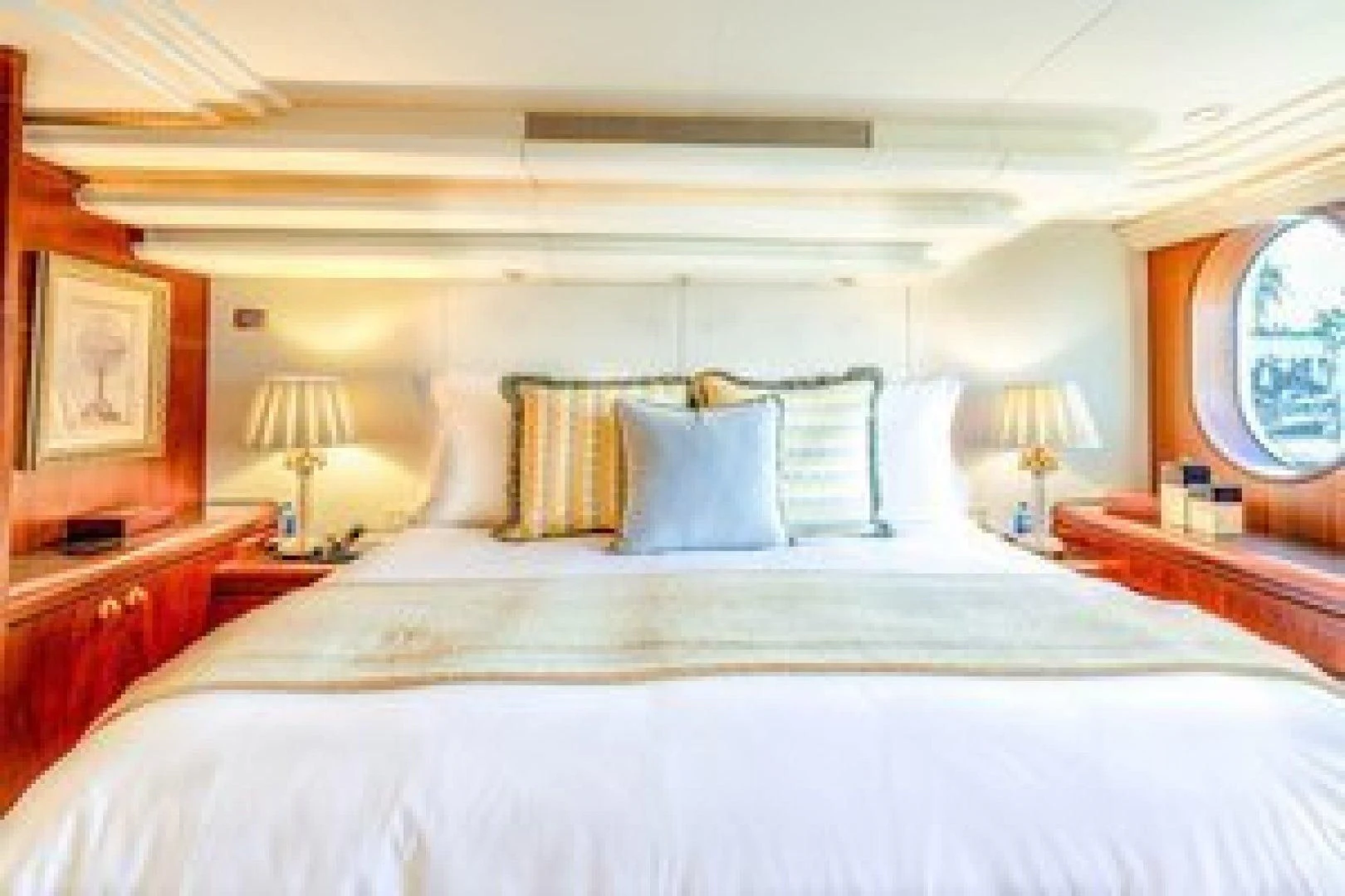 a bed with white sheets and pillows aboard NEVER ENOUGH Yacht for Charter