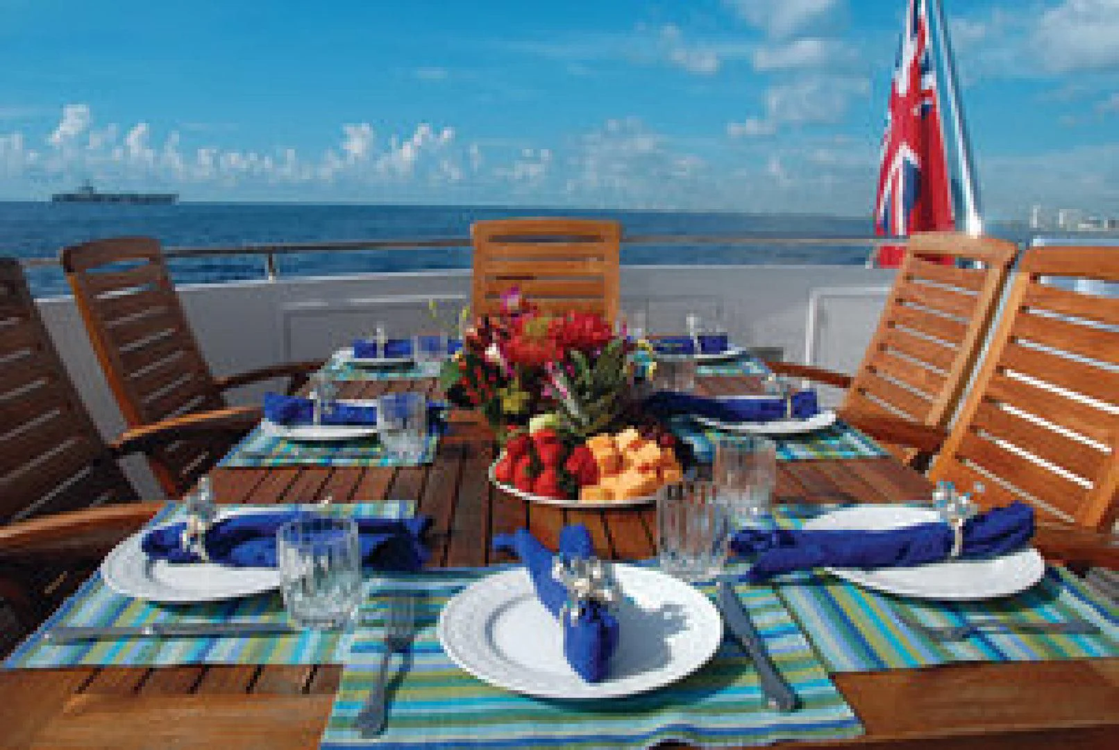 a table with plates and food on it aboard NEVER ENOUGH Yacht for Charter