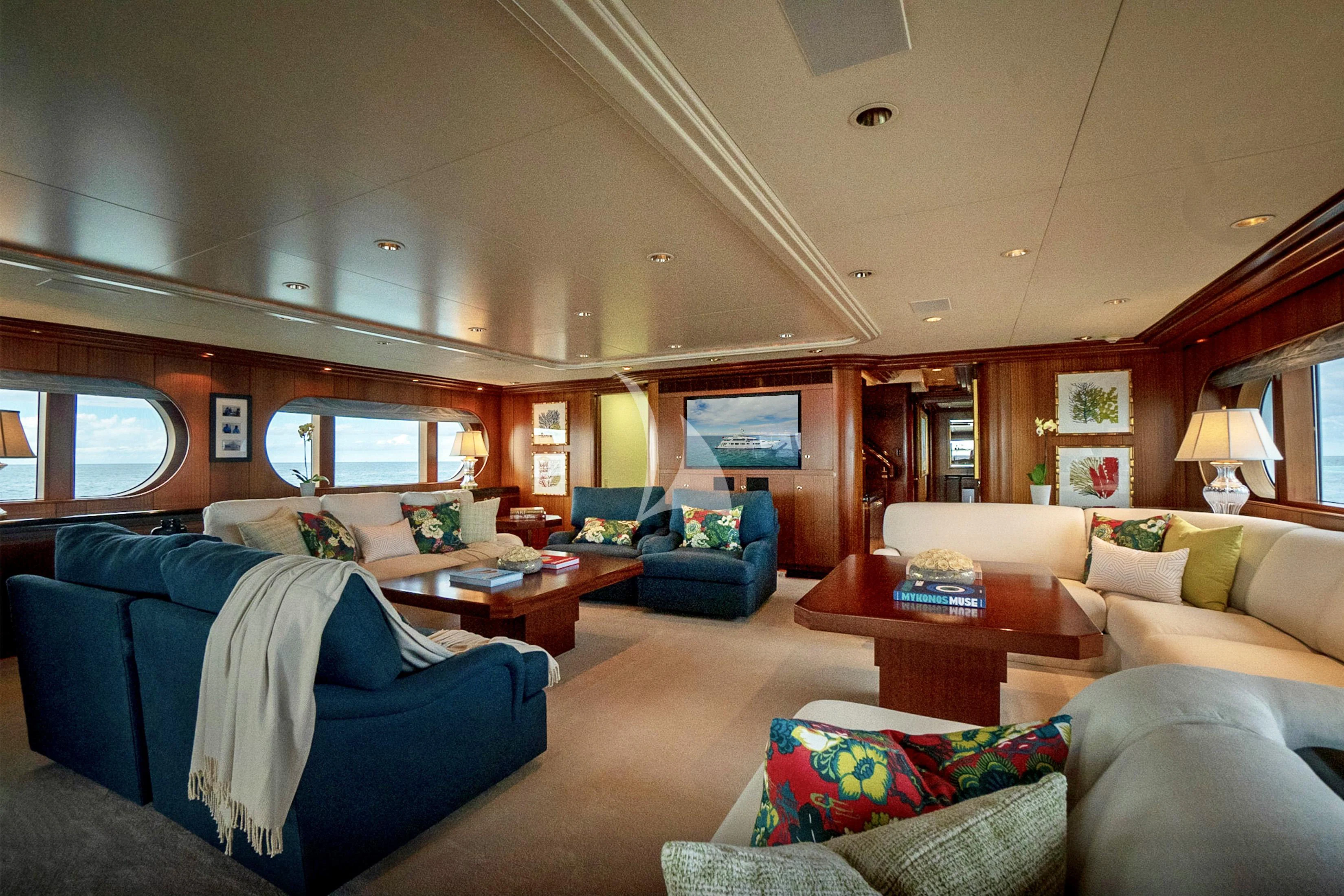a living room with a couch and a table aboard NEVER ENOUGH Yacht for Charter