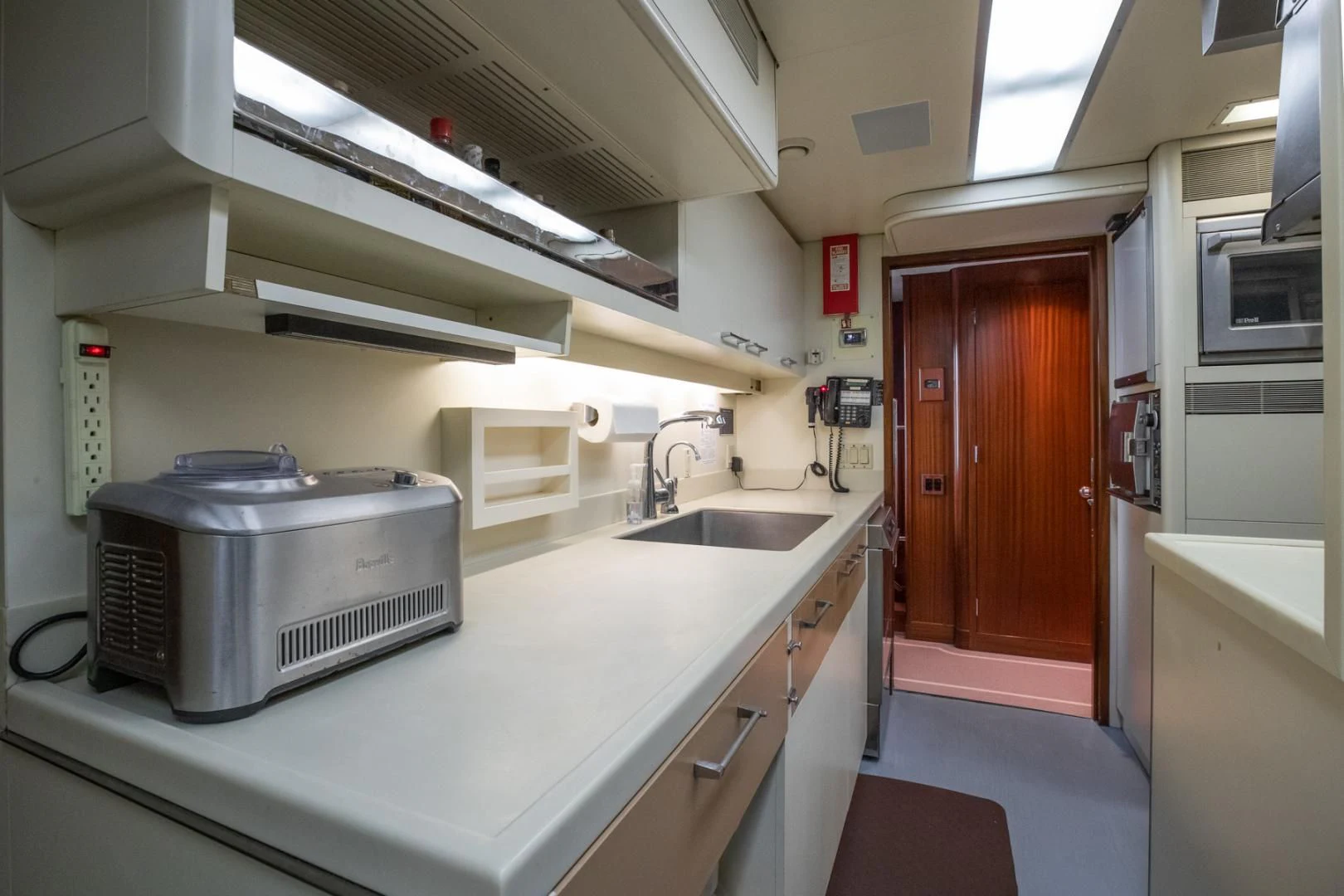 a kitchen with a sink and a microwave aboard NEVER ENOUGH Yacht for Charter