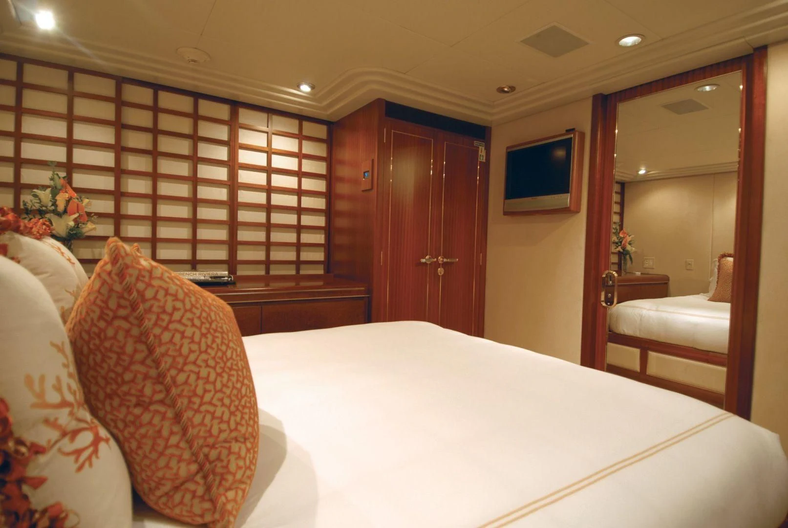 a bedroom with a bed and a television aboard NEVER ENOUGH Yacht for Charter