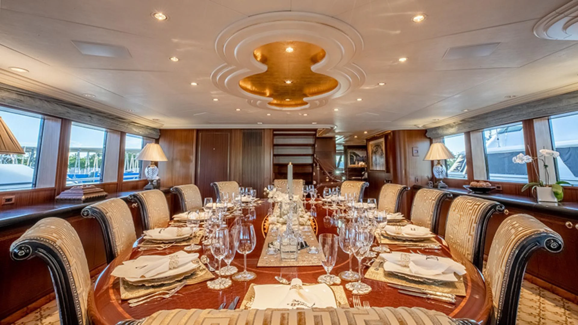 a large dining room with a large chandelier aboard NEVER ENOUGH Yacht for Charter