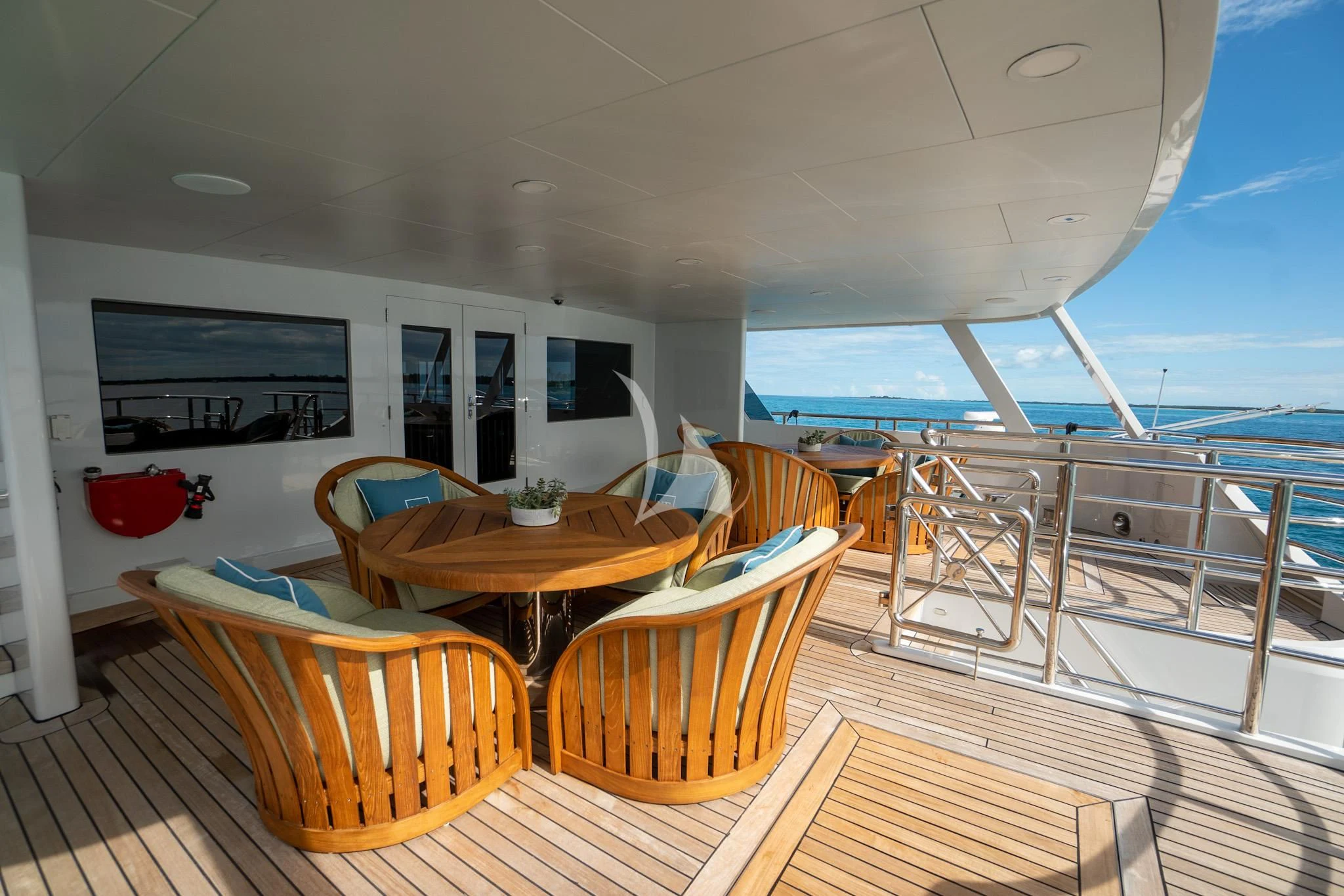 a table and chairs on a deck aboard NEVER ENOUGH Yacht for Charter