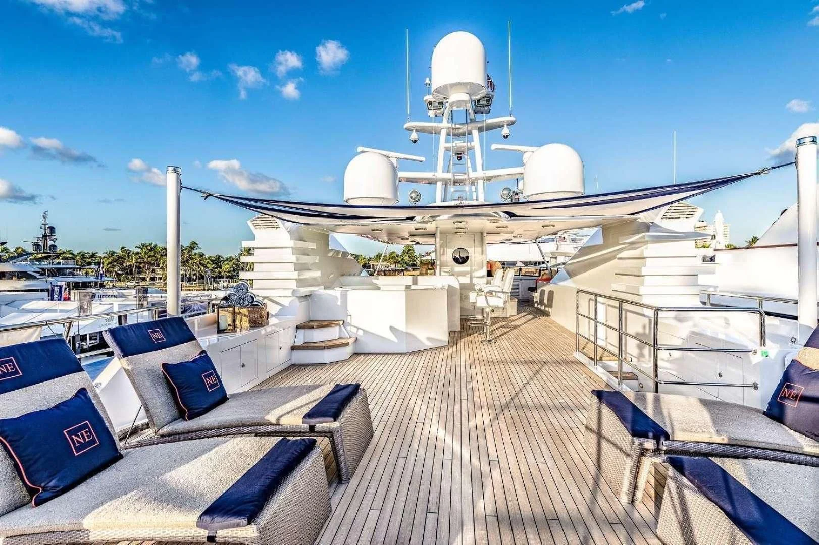 a deck with a large ship in the water aboard NEVER ENOUGH Yacht for Charter