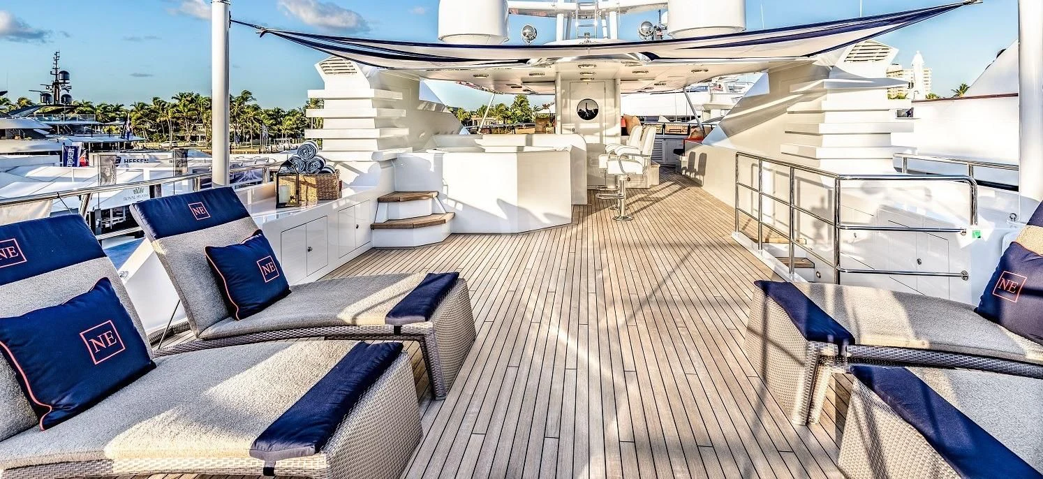 a deck with a deck and a view of the water aboard NEVER ENOUGH Yacht for Charter