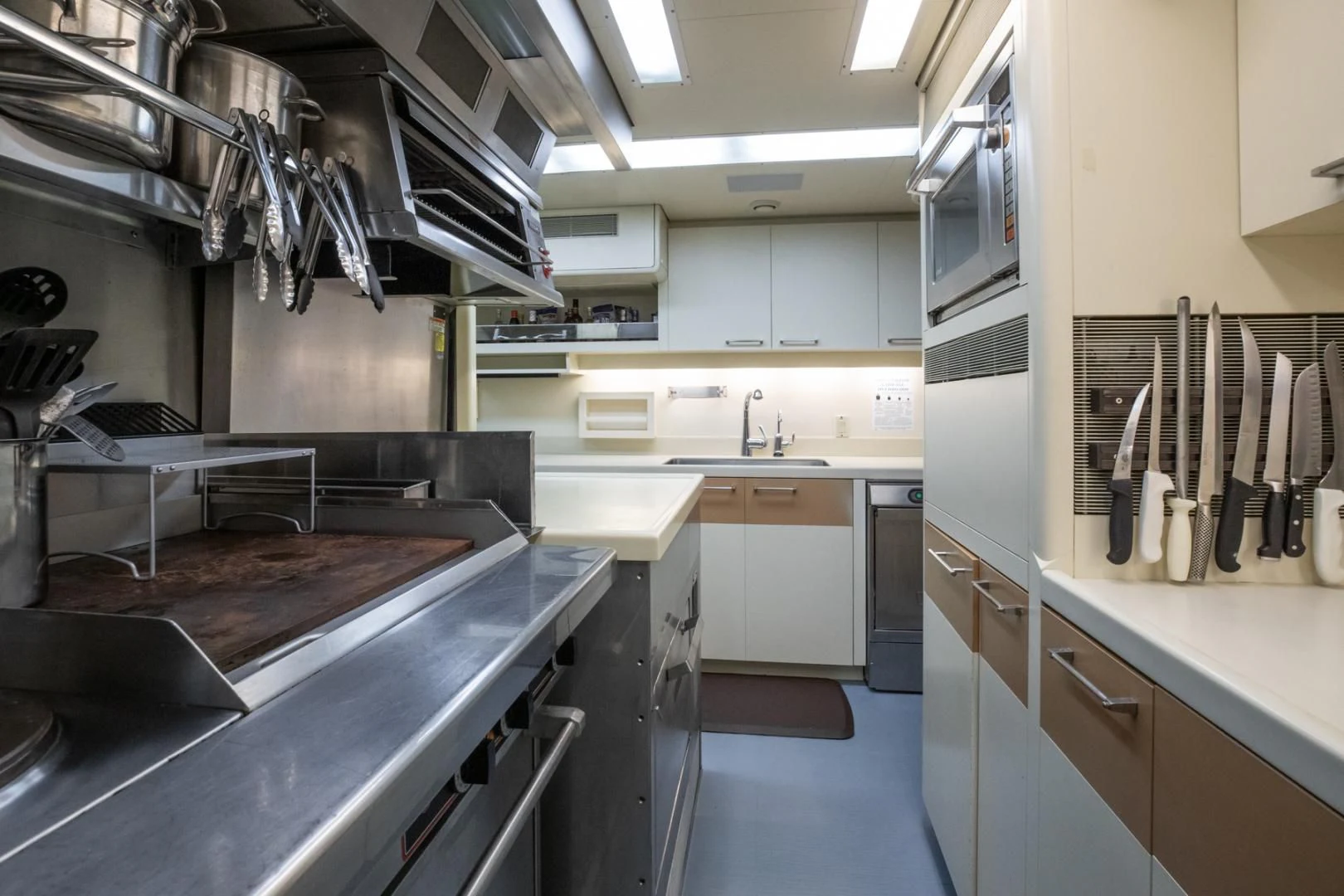 a kitchen with stainless steel appliances aboard NEVER ENOUGH Yacht for Charter