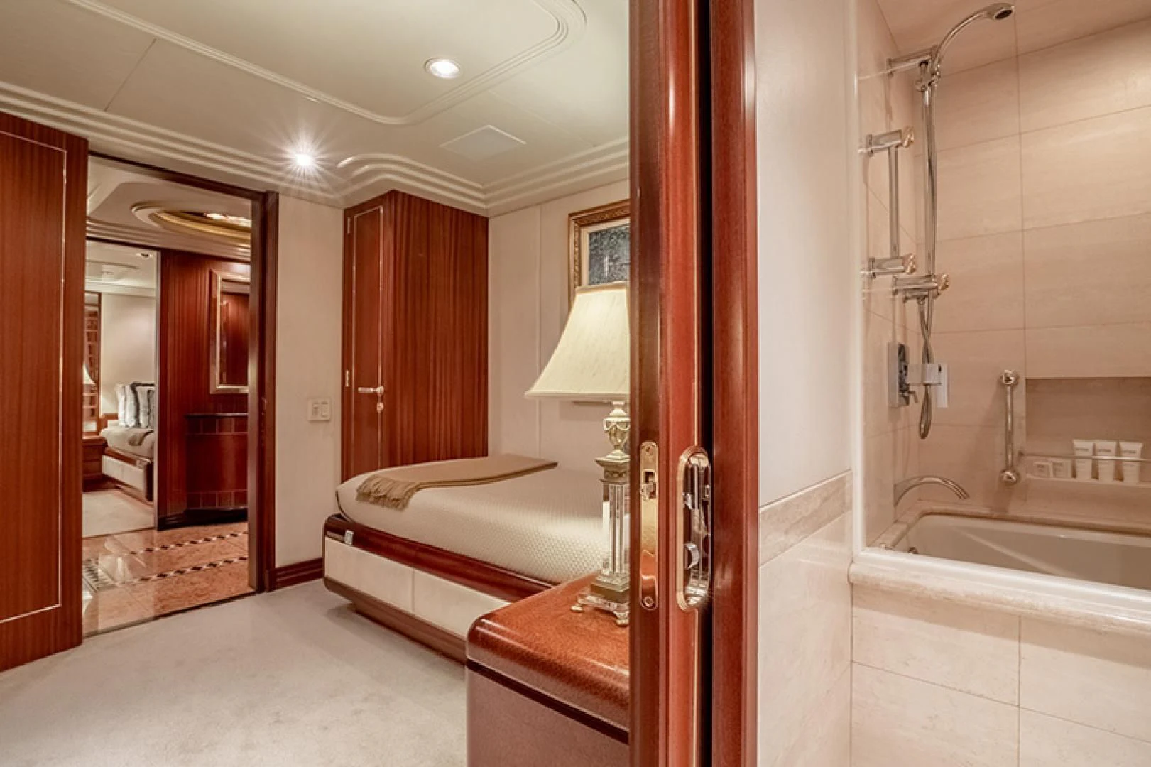 a bathroom with a bed and a bathtub aboard NEVER ENOUGH Yacht for Charter