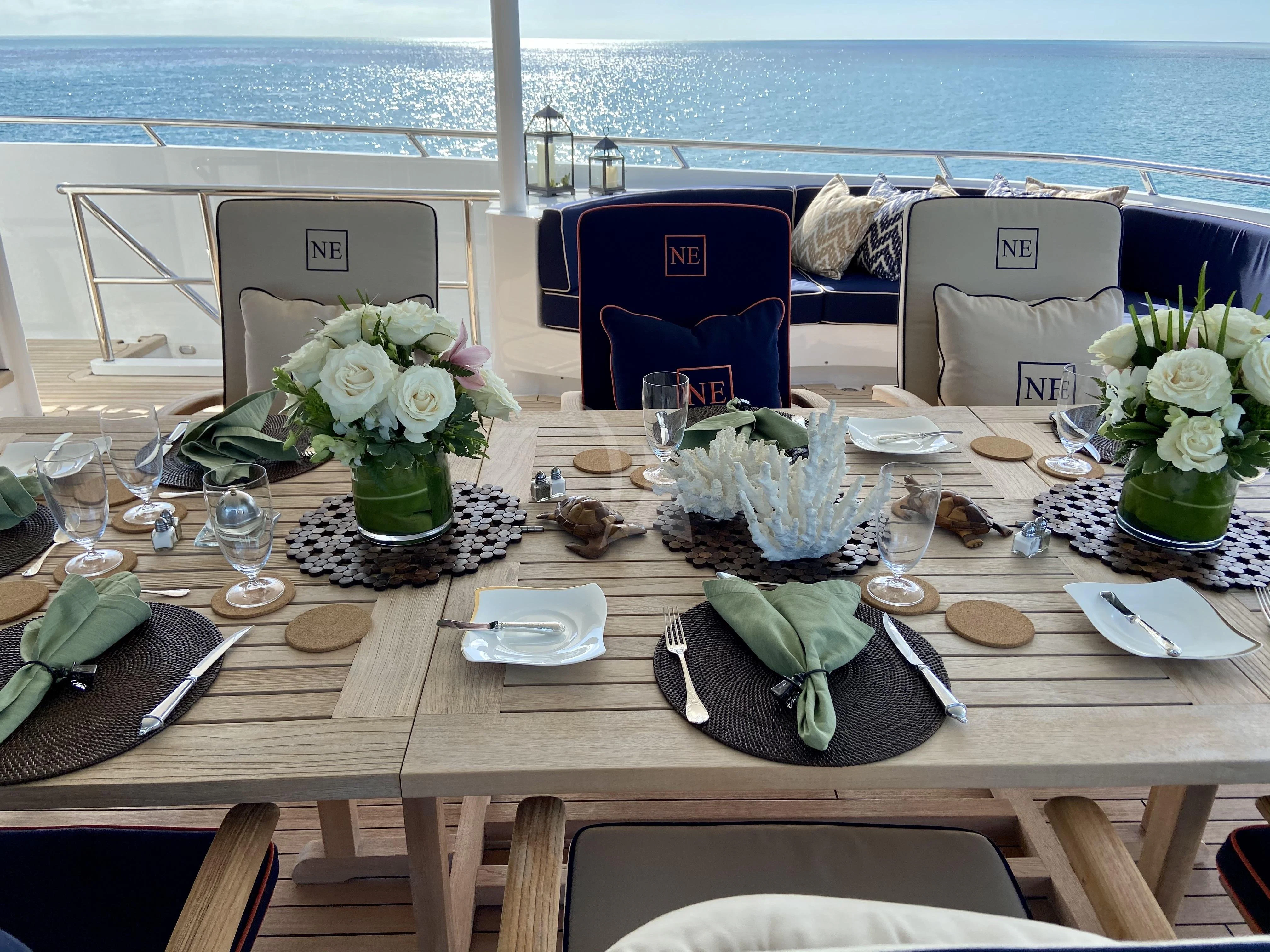 a table with plates and flowers aboard NEVER ENOUGH Yacht for Charter