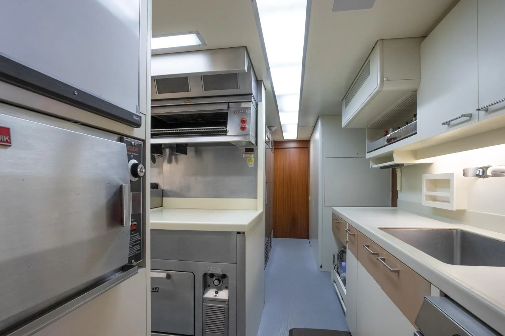 a kitchen with a stainless steel oven aboard NEVER ENOUGH Yacht for Charter
