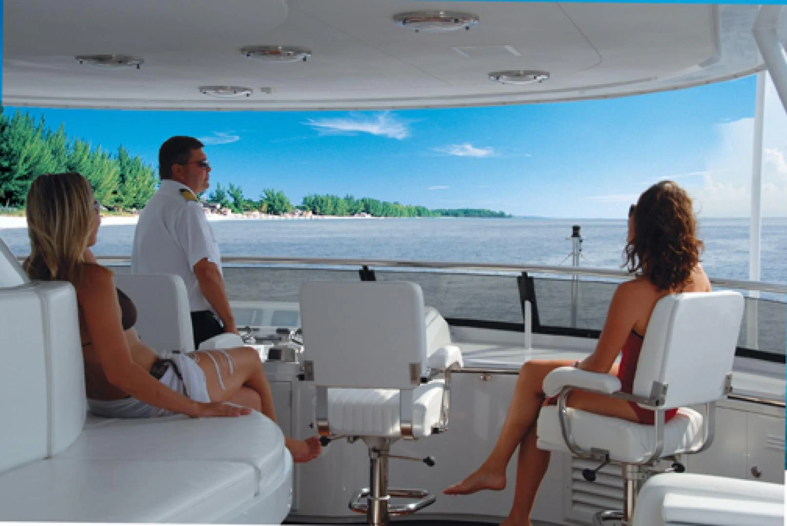 a man and woman sitting on a boat aboard NEVER ENOUGH Yacht for Charter