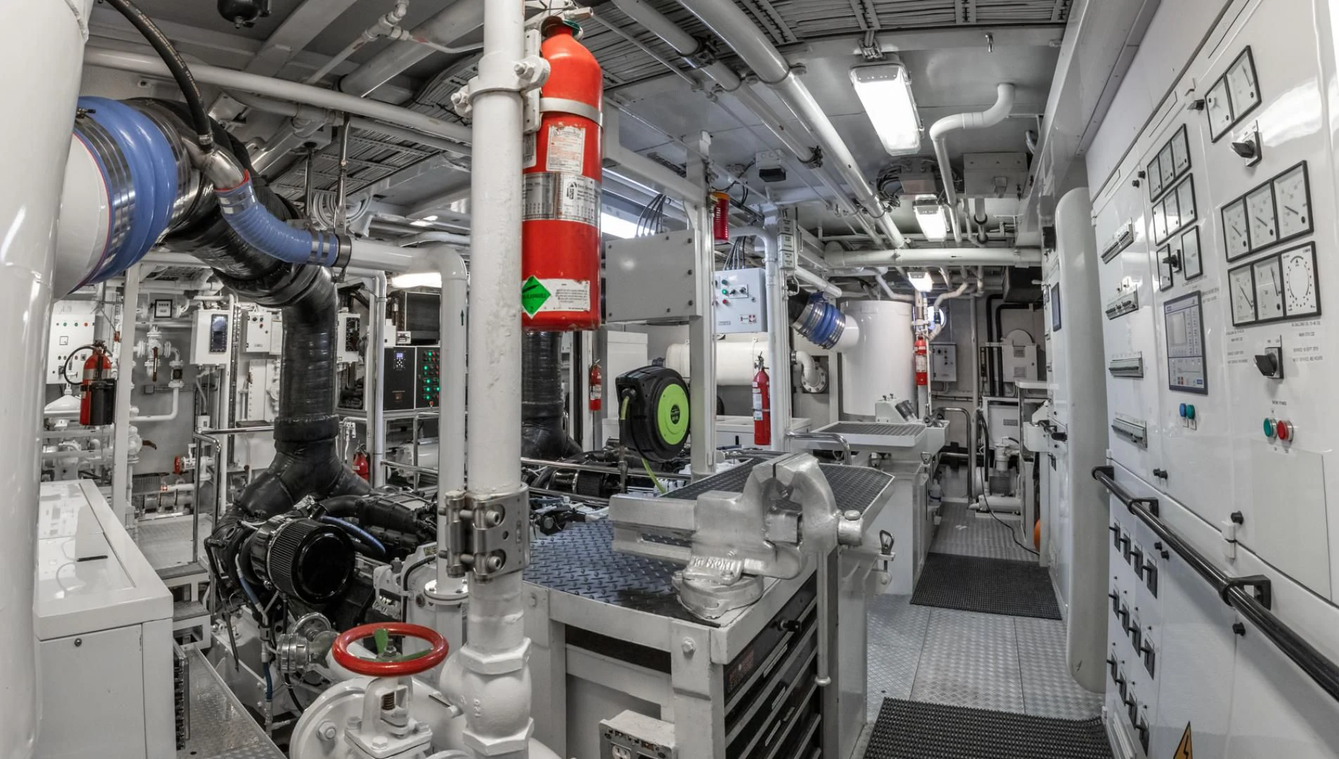 a room with white walls and machinery aboard NEVER ENOUGH Yacht for Charter