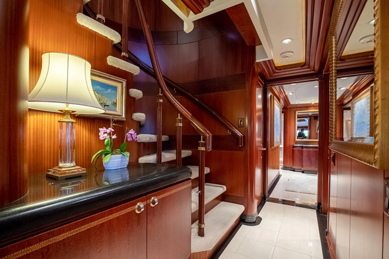 a room with a lamp and a staircase aboard NEVER ENOUGH Yacht for Charter