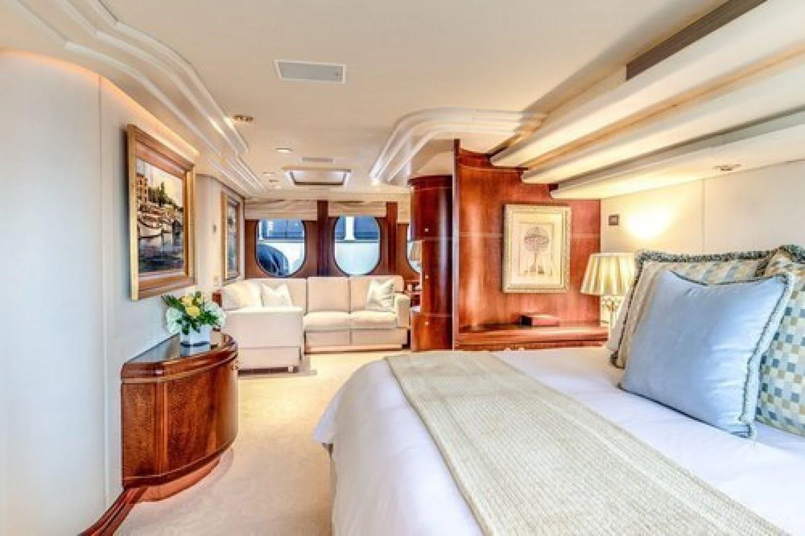 a bedroom with a bed and a chair aboard NEVER ENOUGH Yacht for Charter