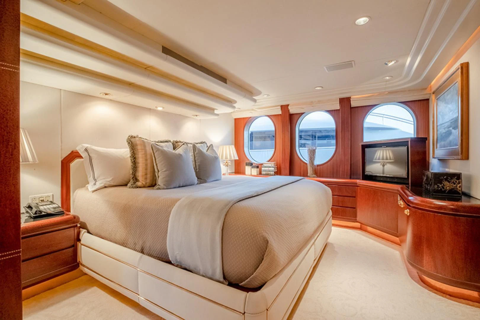 a bedroom with a bed and a television aboard NEVER ENOUGH Yacht for Charter