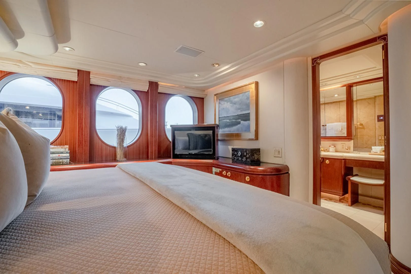 a bedroom with a bed and a tv aboard NEVER ENOUGH Yacht for Charter