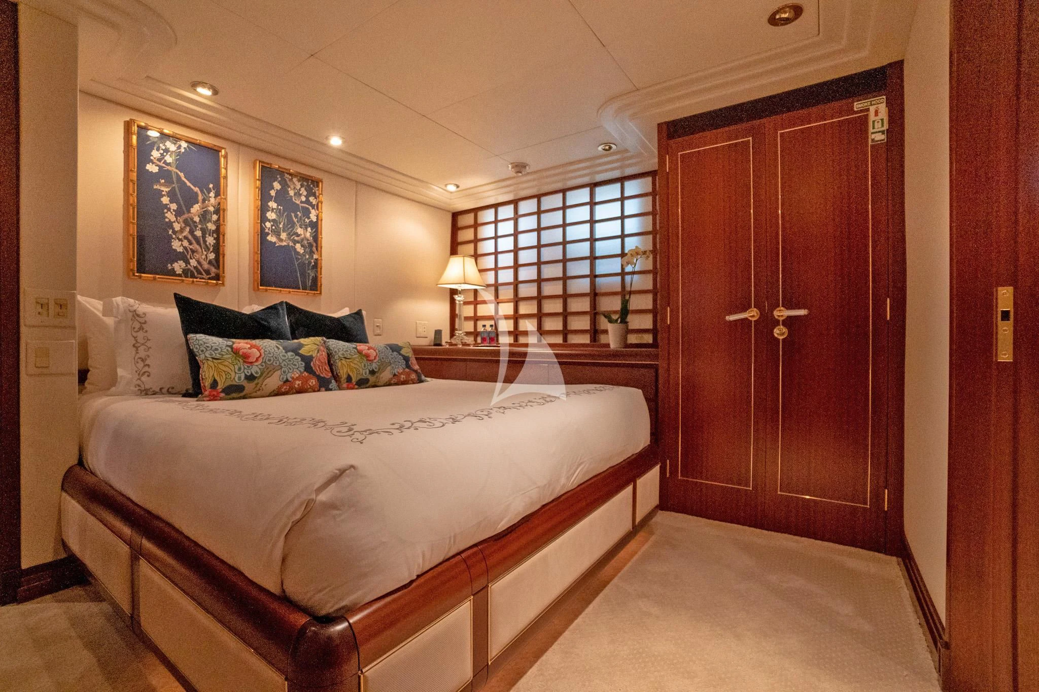 a bedroom with a bed and a door aboard NEVER ENOUGH Yacht for Charter