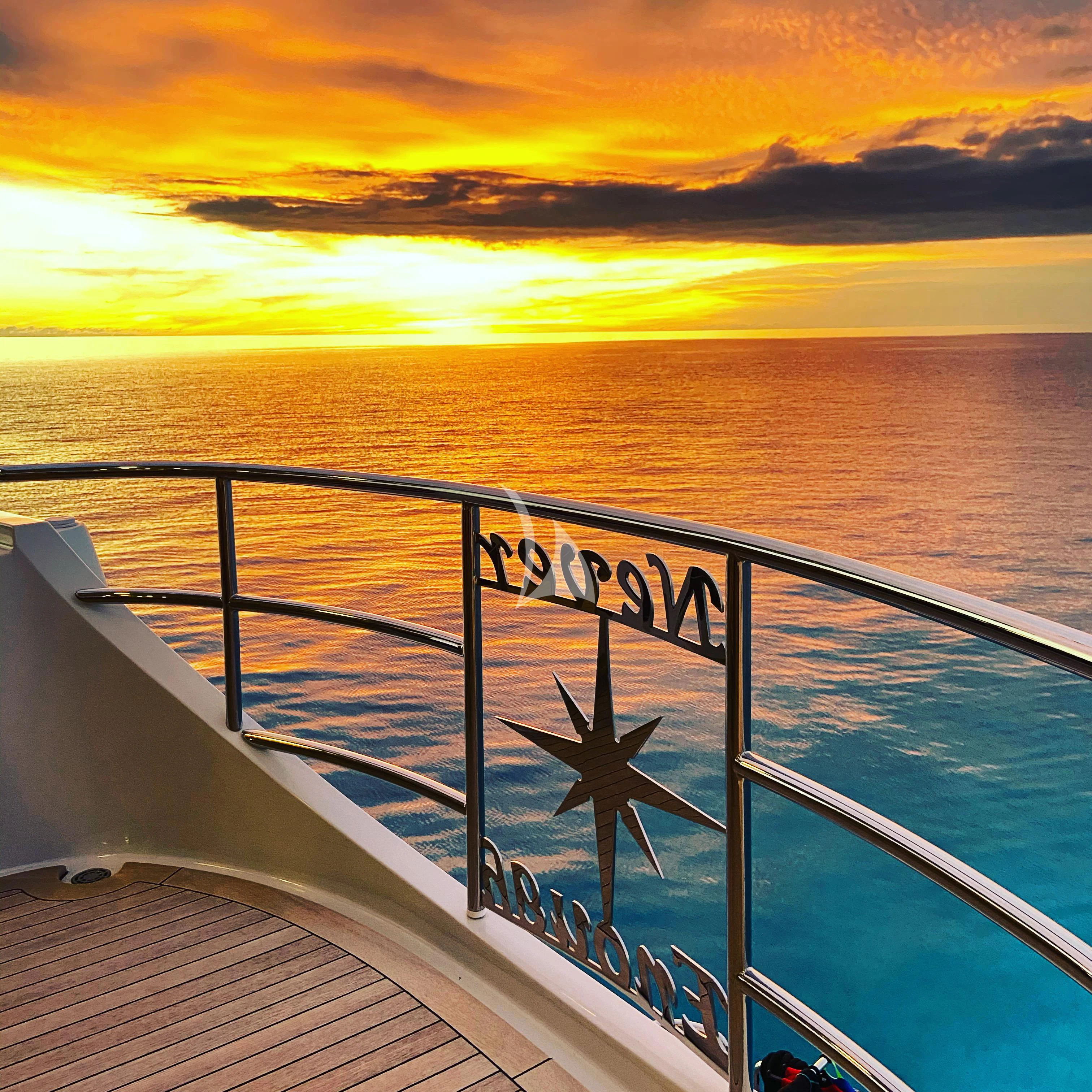 a large ship with a wind turbine aboard NEVER ENOUGH Yacht for Charter