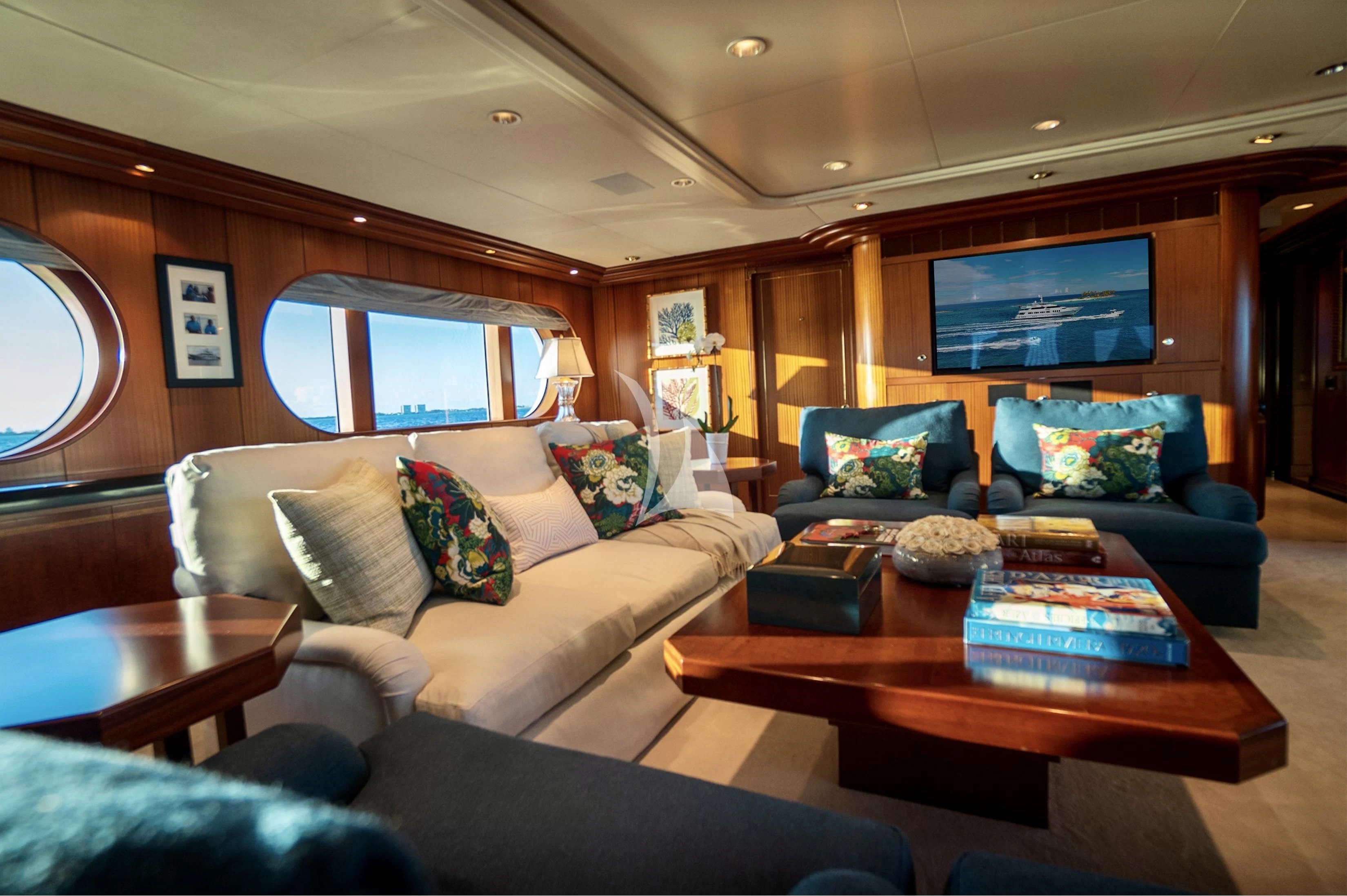 a living room with a couch and a coffee table aboard NEVER ENOUGH Yacht for Charter