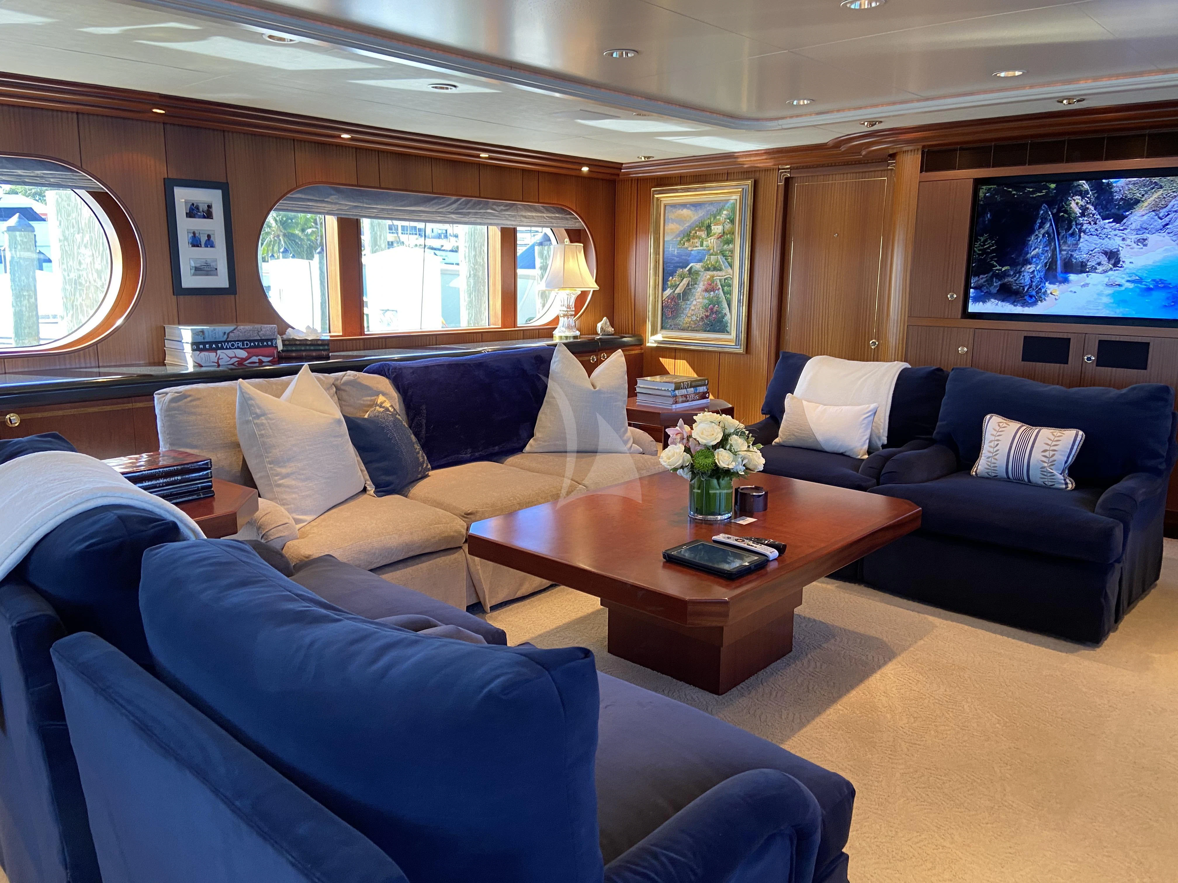 a living room with a couch and a coffee table aboard NEVER ENOUGH Yacht for Charter