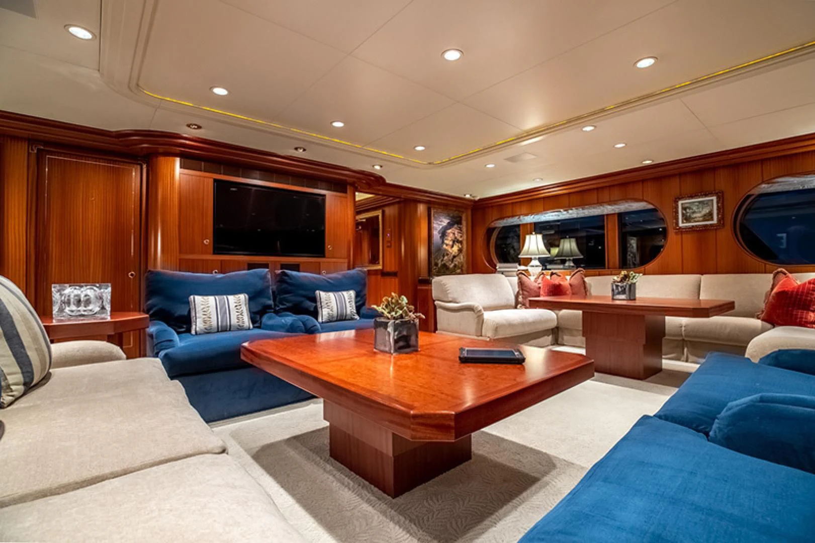 a living room with a table and couches aboard NEVER ENOUGH Yacht for Charter
