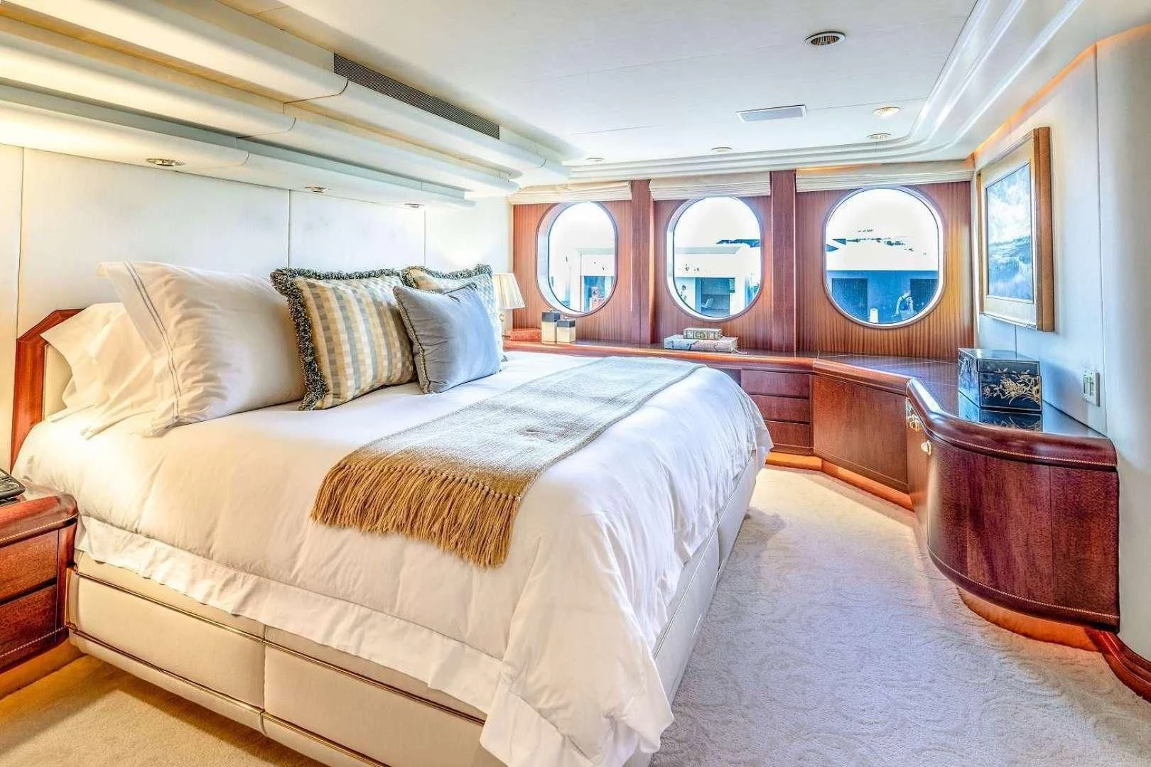 a bed with a white comforter aboard NEVER ENOUGH Yacht for Charter