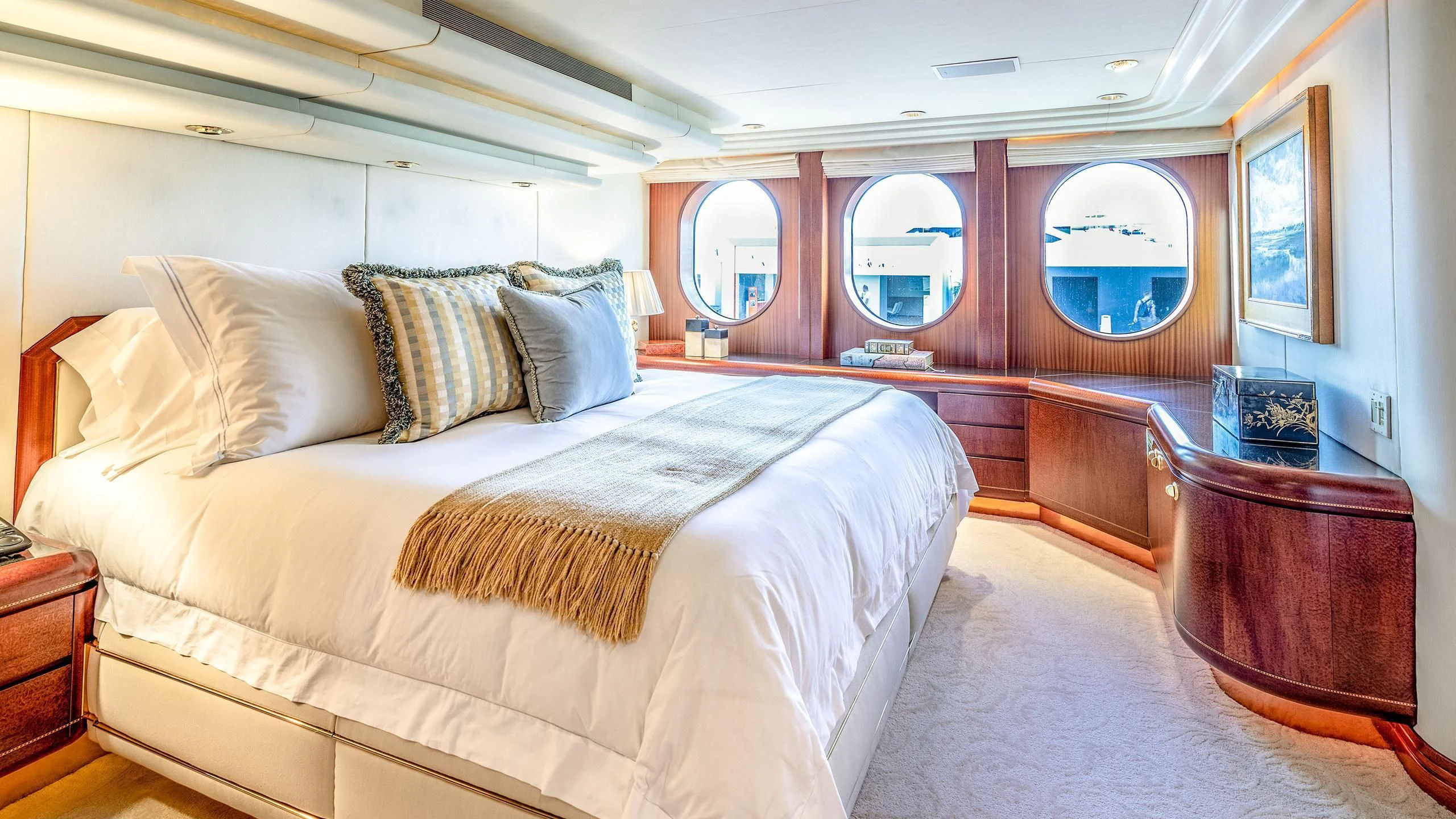 a bed with a white comforter aboard NEVER ENOUGH Yacht for Charter