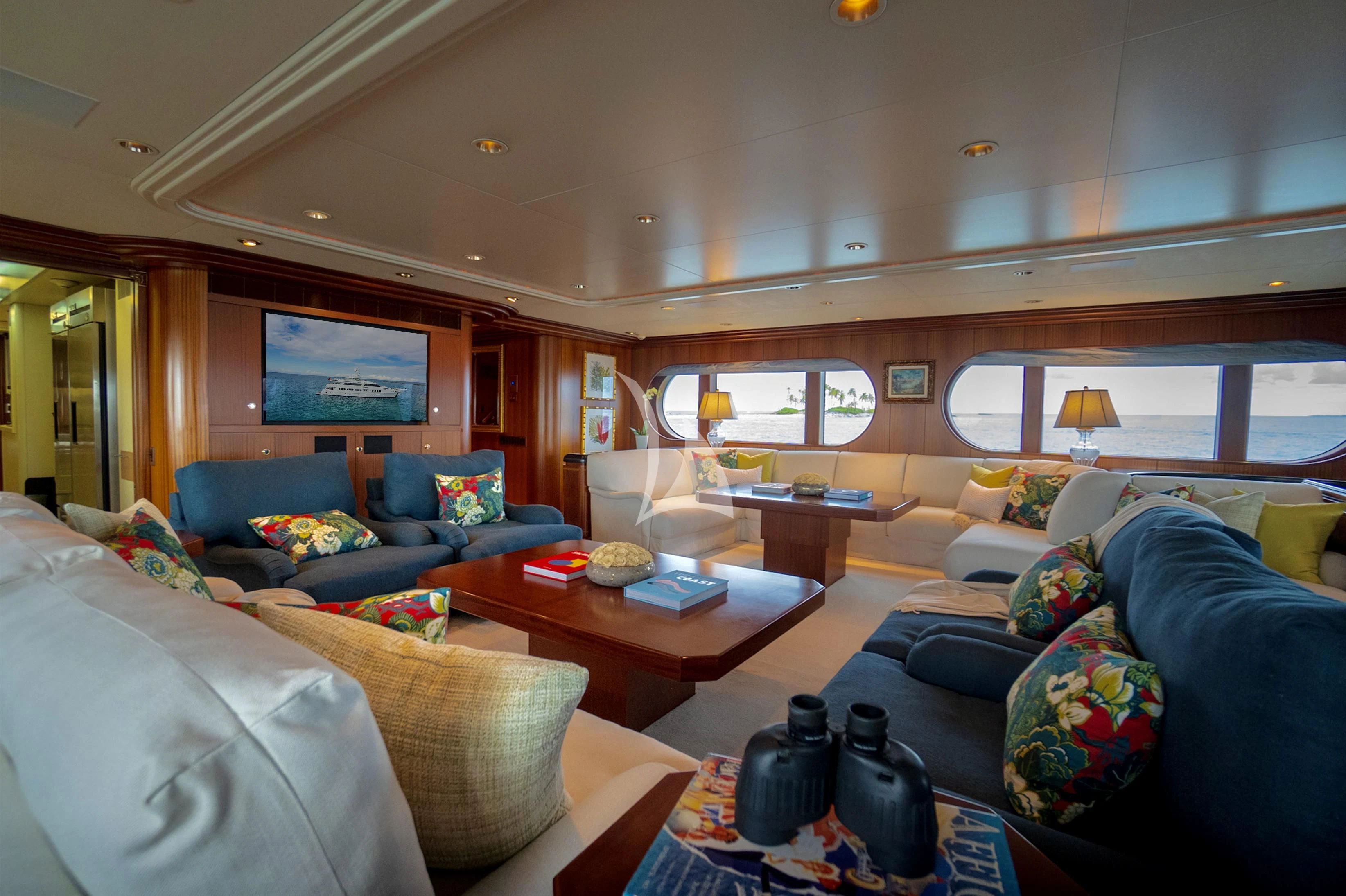 a living room with a couch and a television aboard NEVER ENOUGH Yacht for Charter