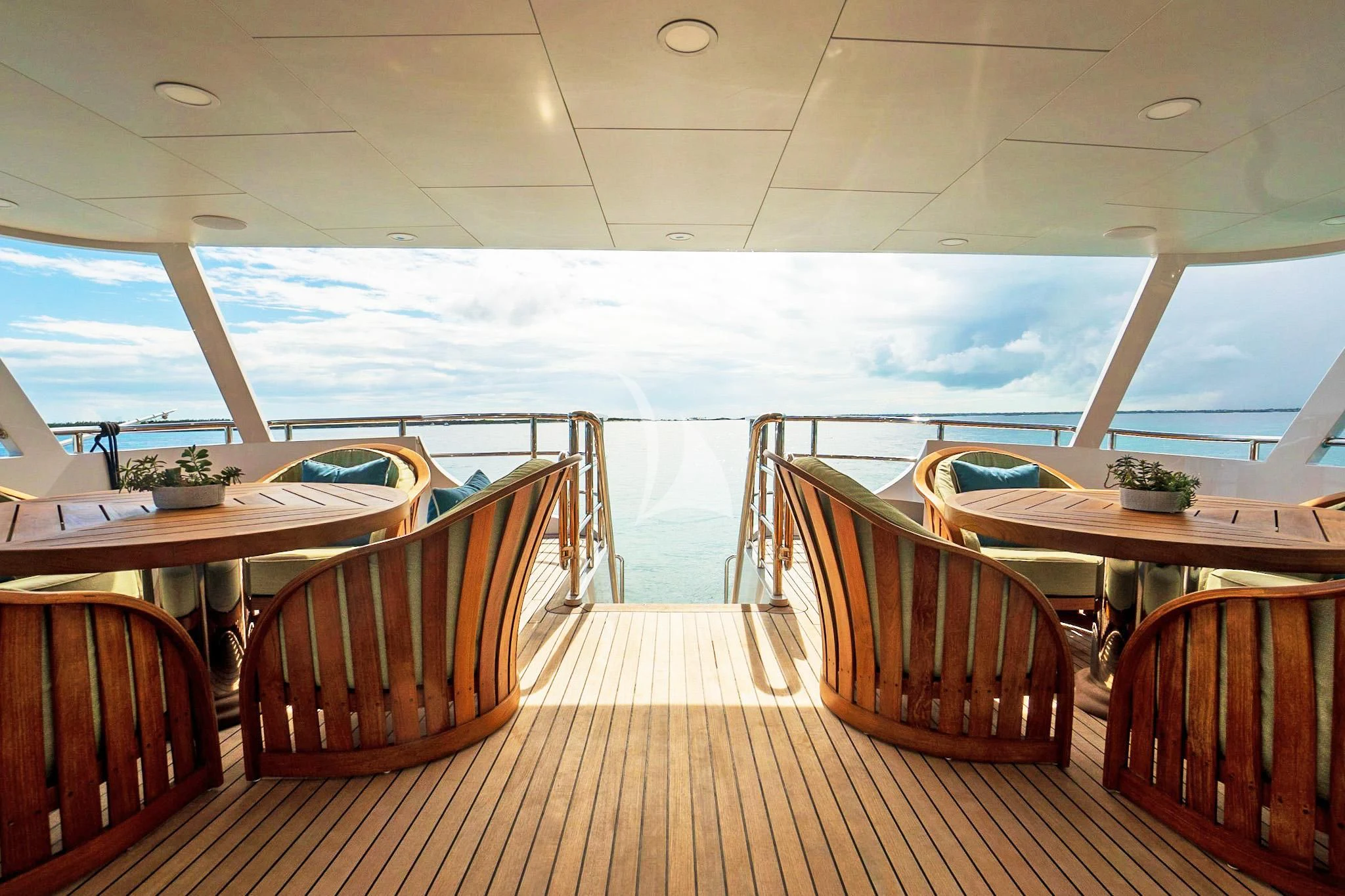 a deck with a table and chairs on it aboard NEVER ENOUGH Yacht for Charter