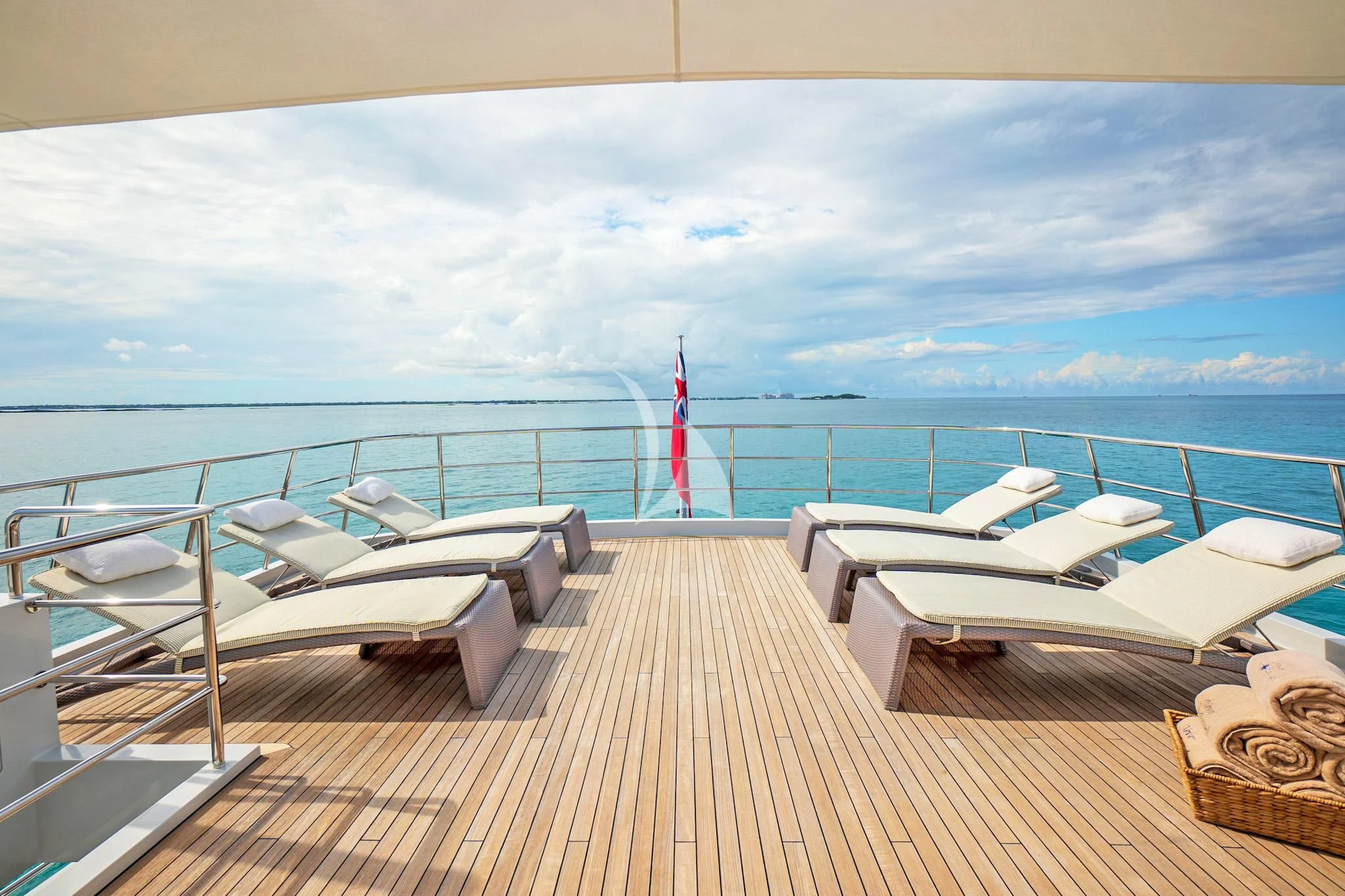 a deck with a view of the ocean and a few boats aboard NEVER ENOUGH Yacht for Charter