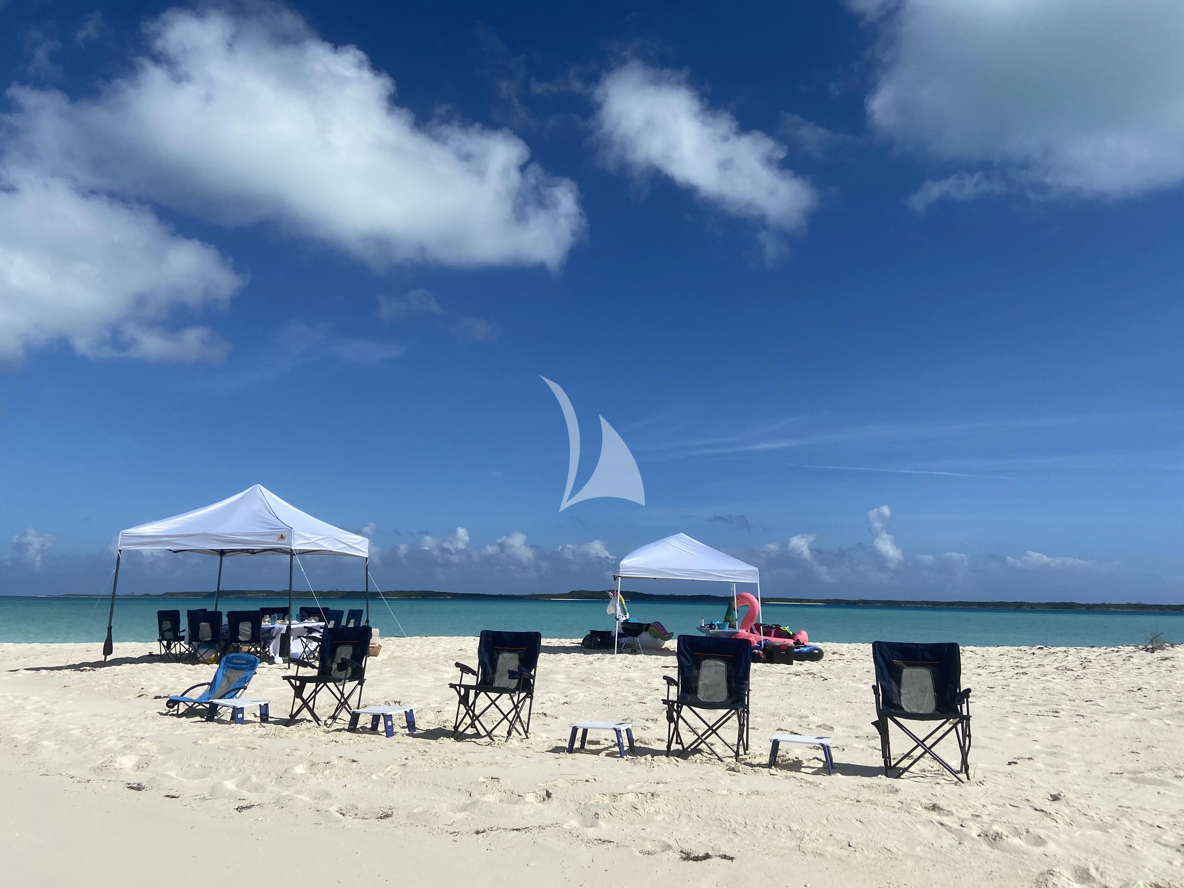 chairs on a beach aboard NEVER ENOUGH Yacht for Charter