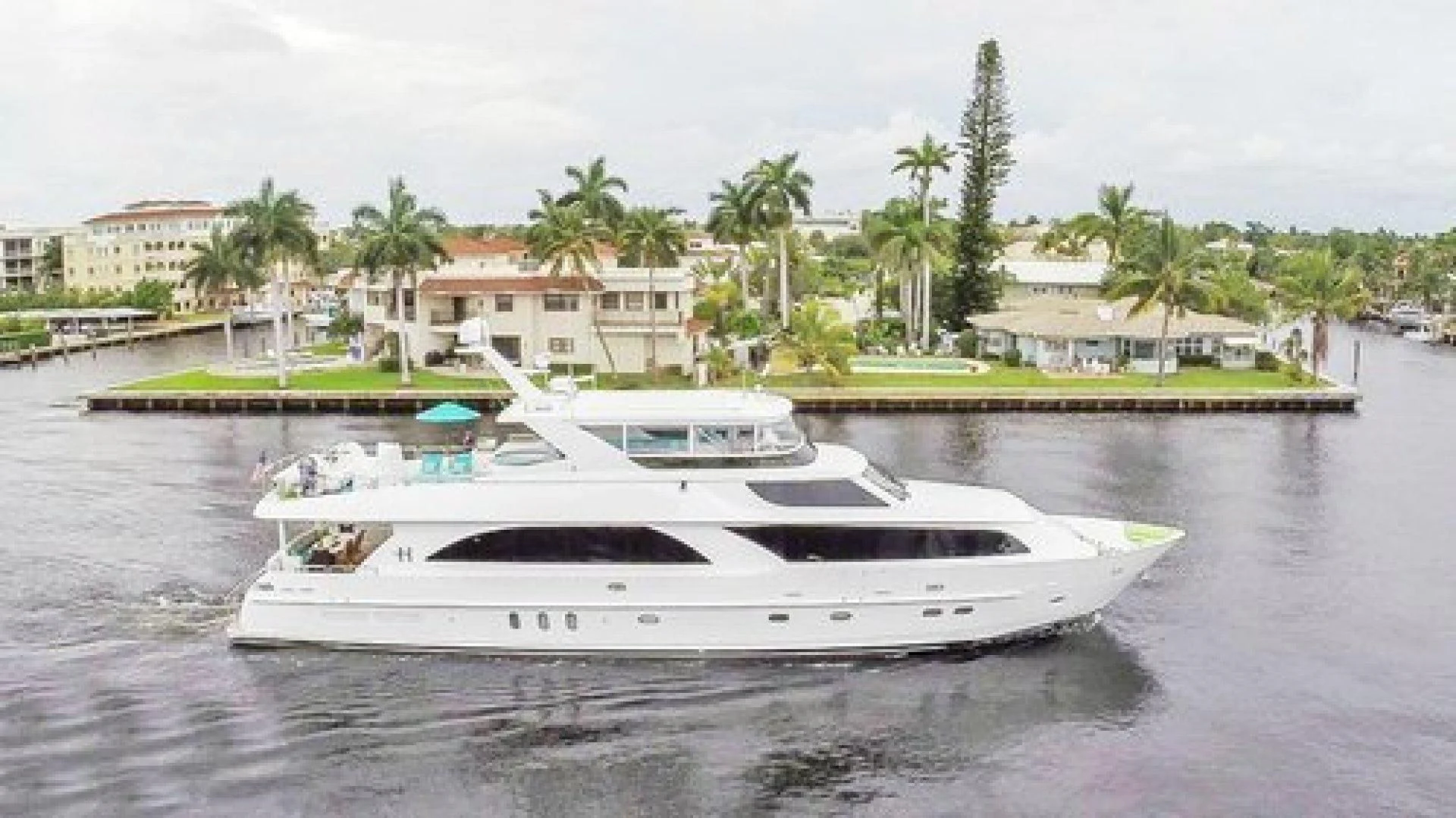 a white boat on a body of water aboard NEVER ENOUGH Yacht for Charter