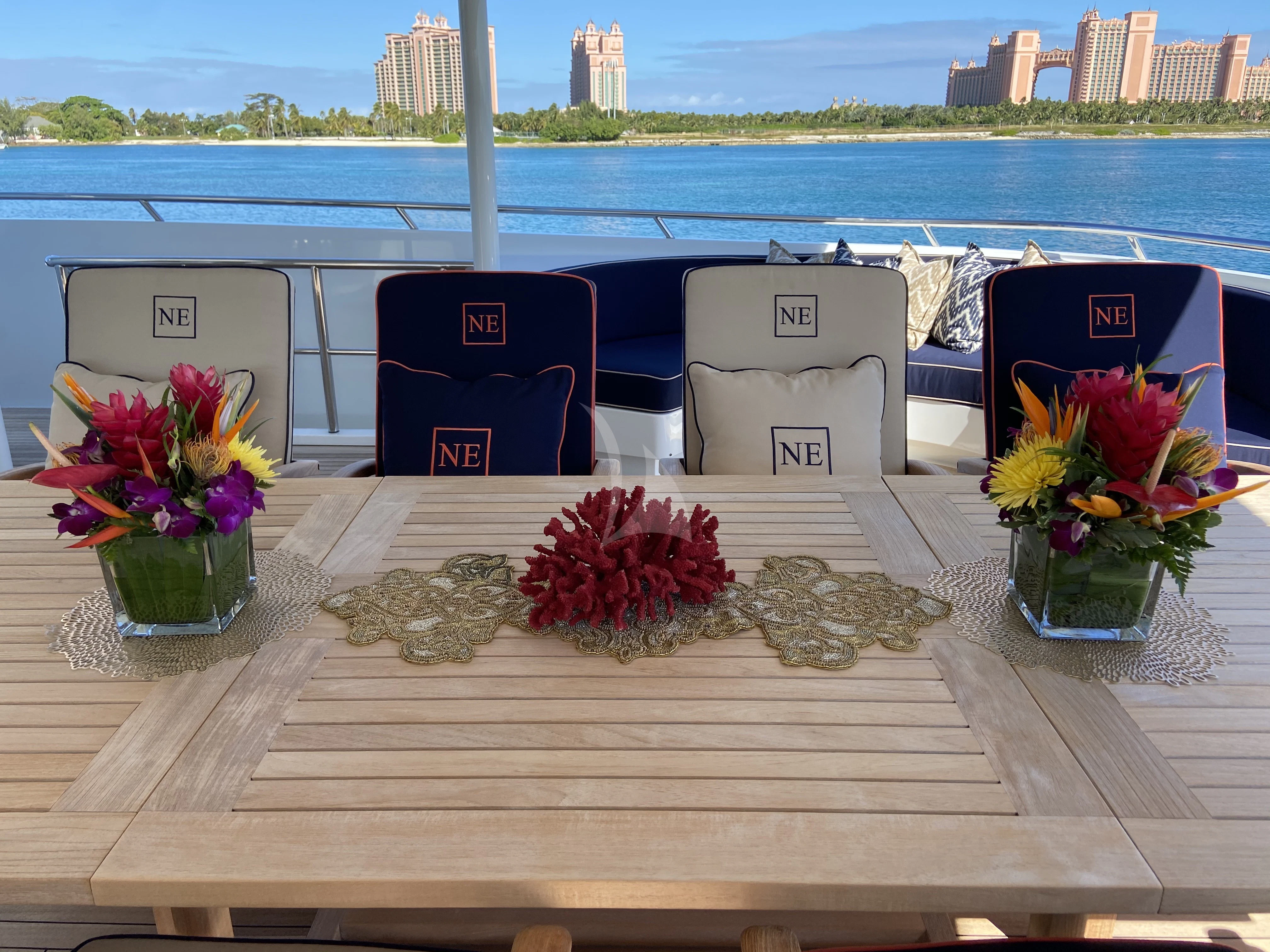 a table with chairs and flowers on it aboard NEVER ENOUGH Yacht for Charter